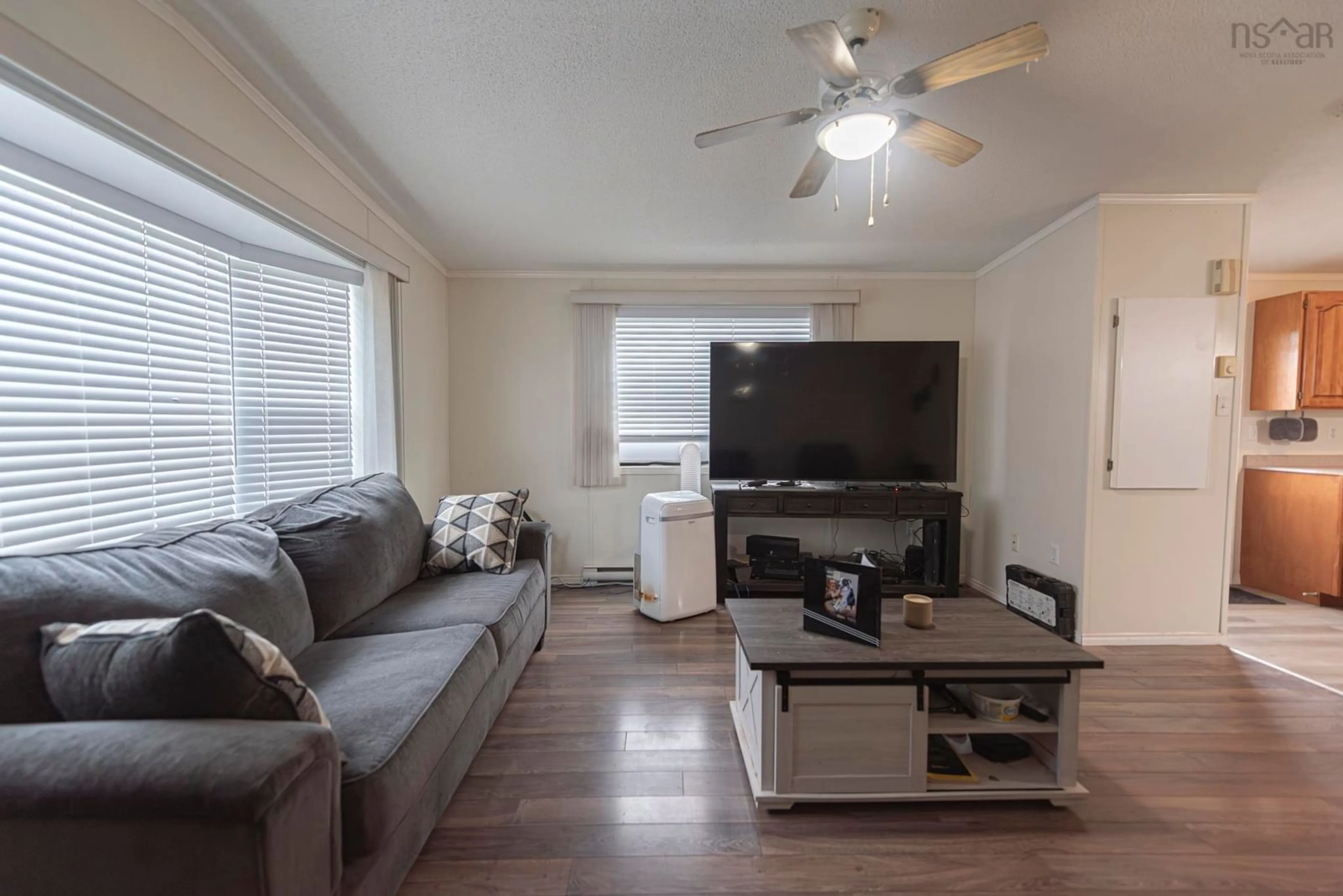 Living room with furniture, wood/laminate floor for 10 High Street Estates, New Glasgow Nova Scotia B2H 4B8