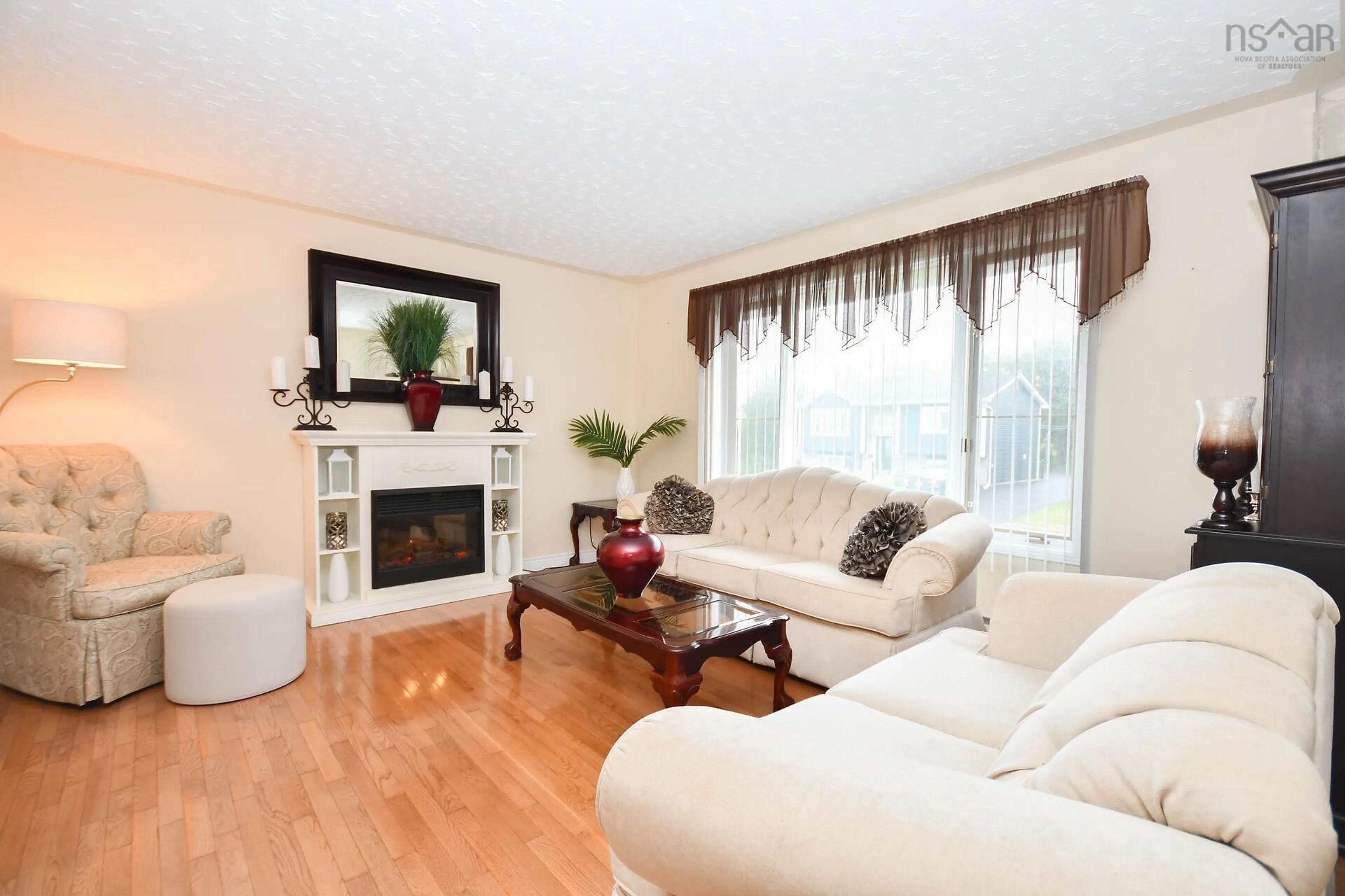 Living room with furniture, wood/laminate floor for 32 Sherwood St, Colby Nova Scotia B2V 2P4