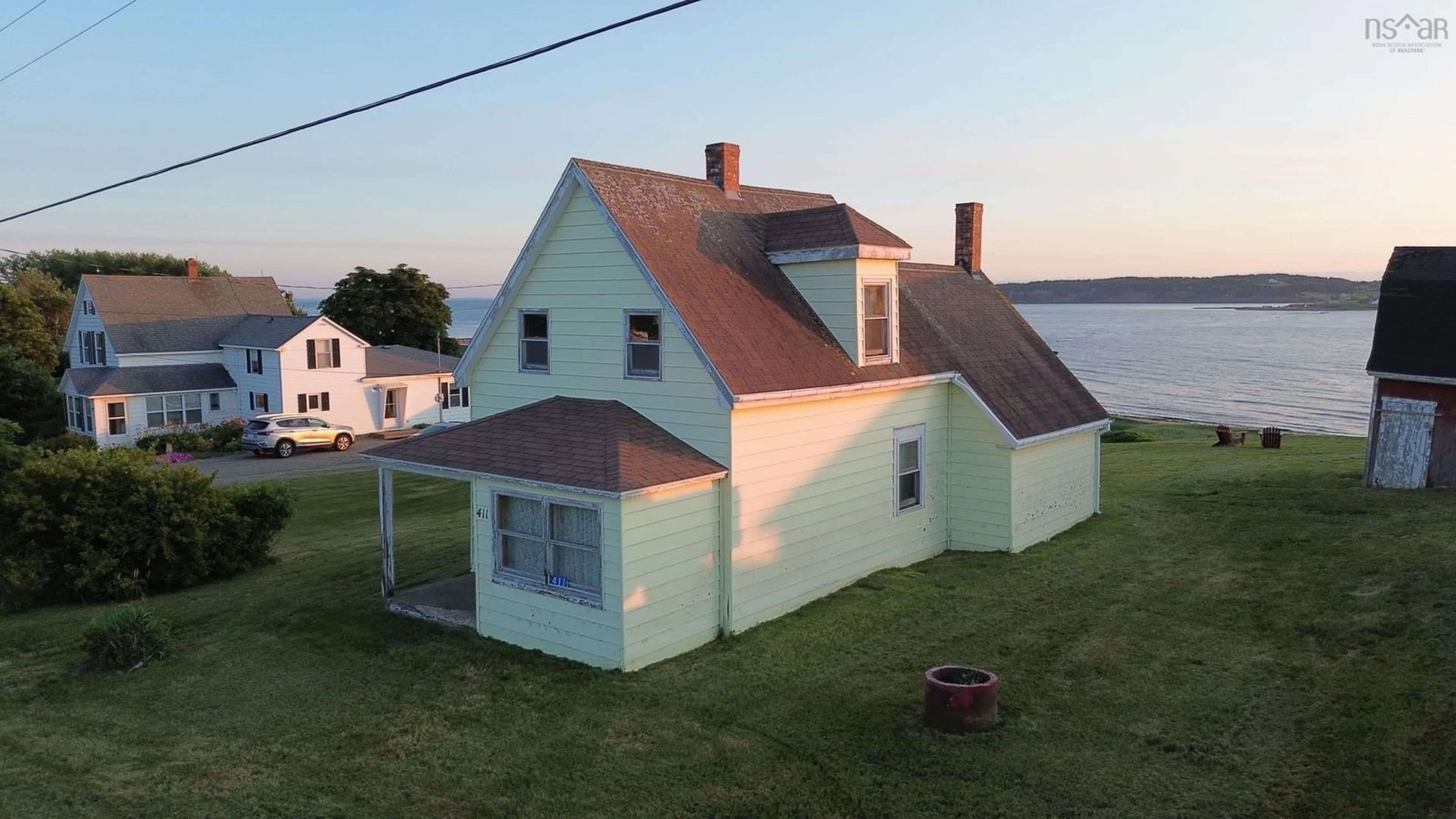 A pic from outside/outdoor area/front of a property/back of a property/a pic from drone, water/lake/river/ocean view for 411 Main St, Port Hood Nova Scotia B0E 2W0