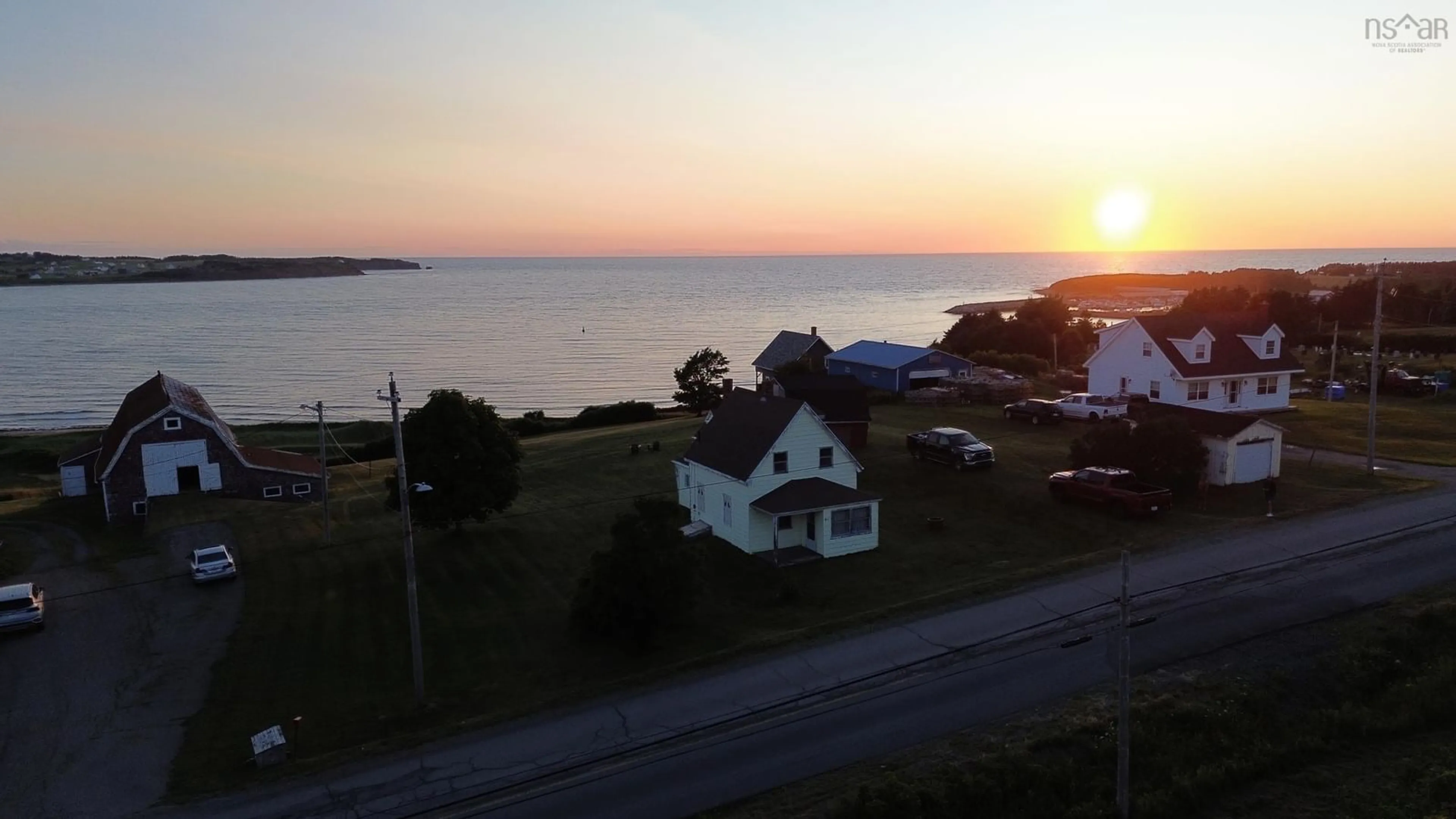 A pic from outside/outdoor area/front of a property/back of a property/a pic from drone, water/lake/river/ocean view for 411 Main St, Port Hood Nova Scotia B0E 2W0