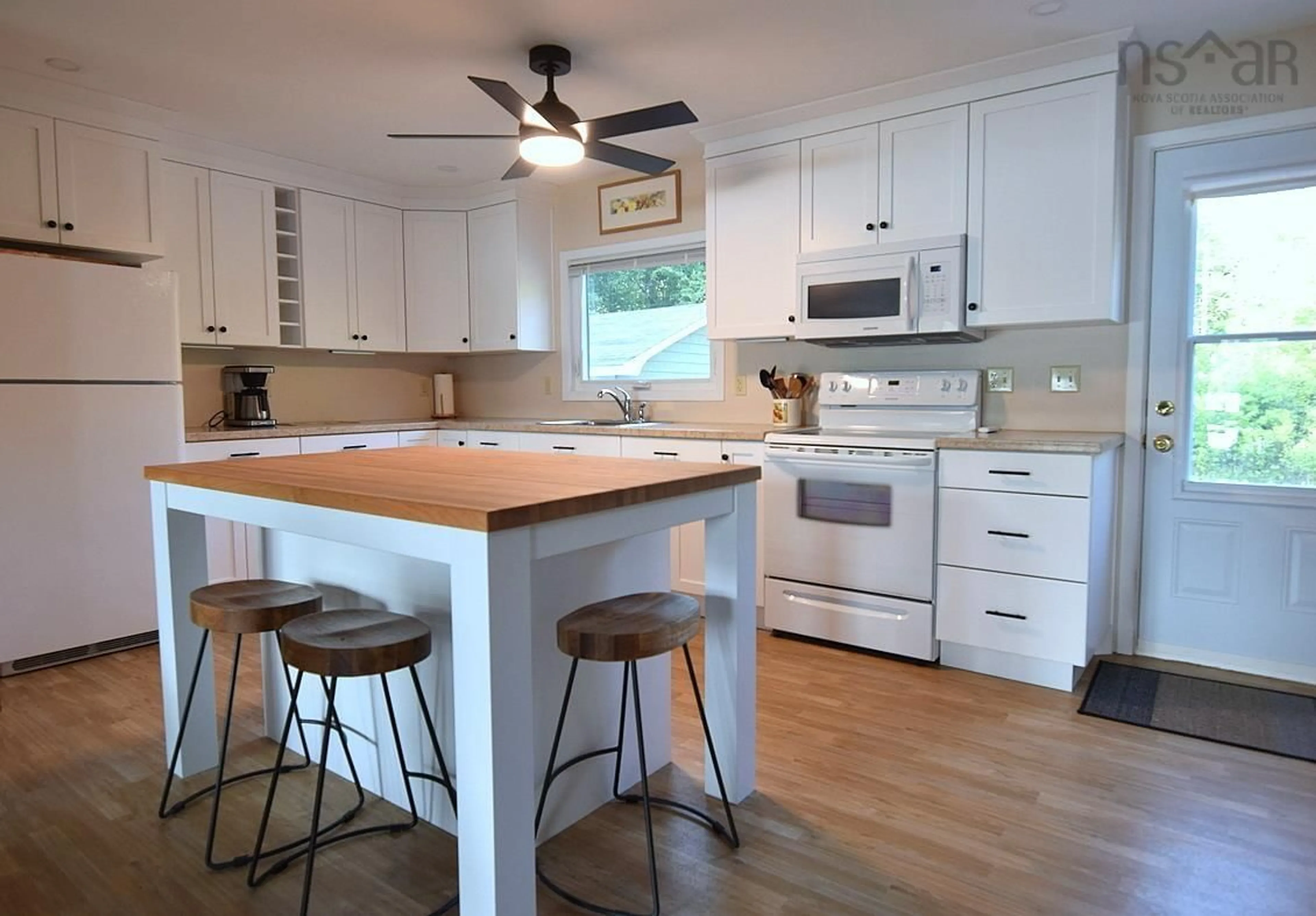 Open concept kitchen, wood/laminate floor for 1707 Highway 395, East Lake Ainslie Nova Scotia B0E 3M0