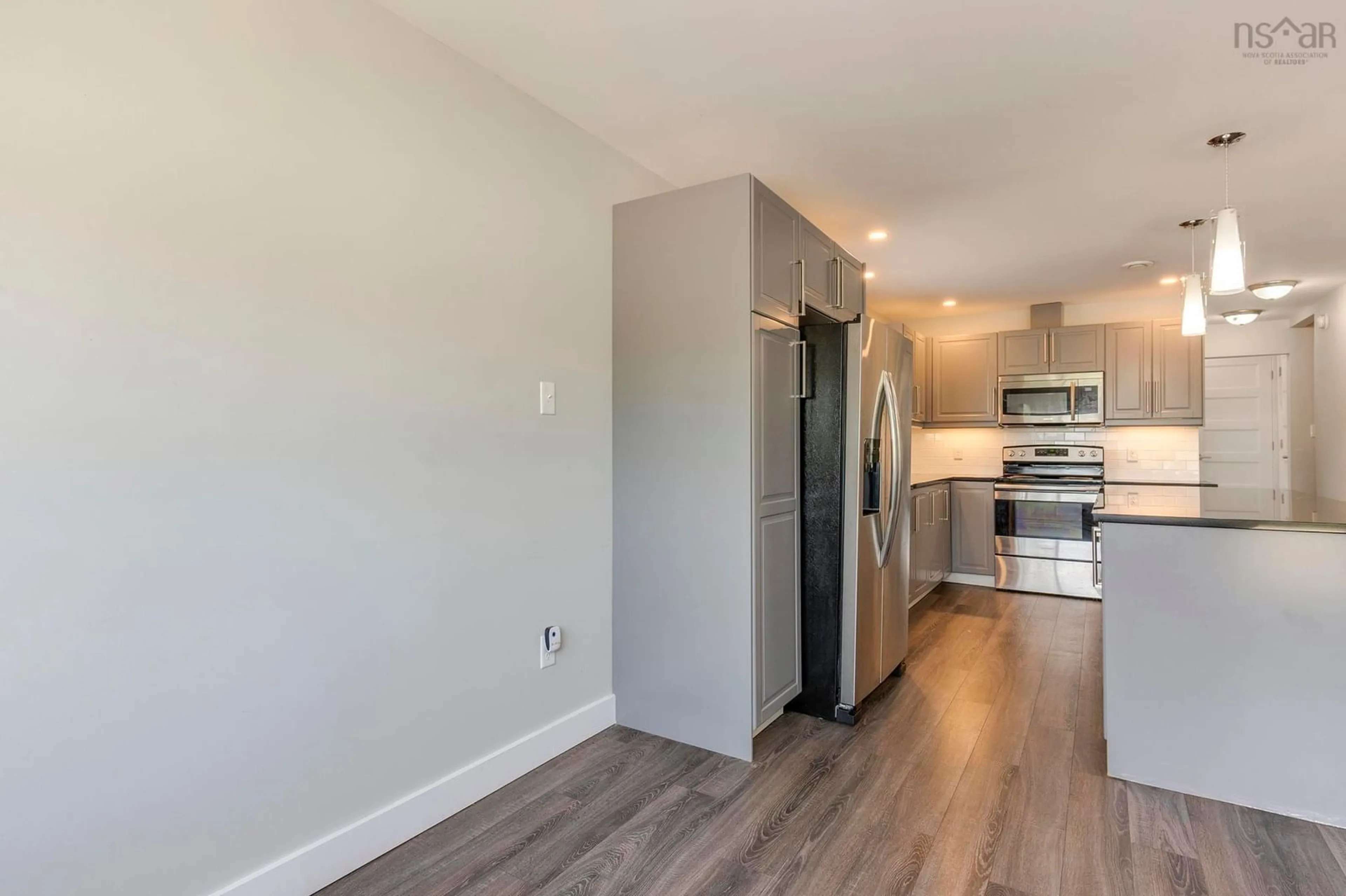 Open concept kitchen, wood/laminate floor for 3356 Devonshire Ave, Halifax Nova Scotia B3K 3M2