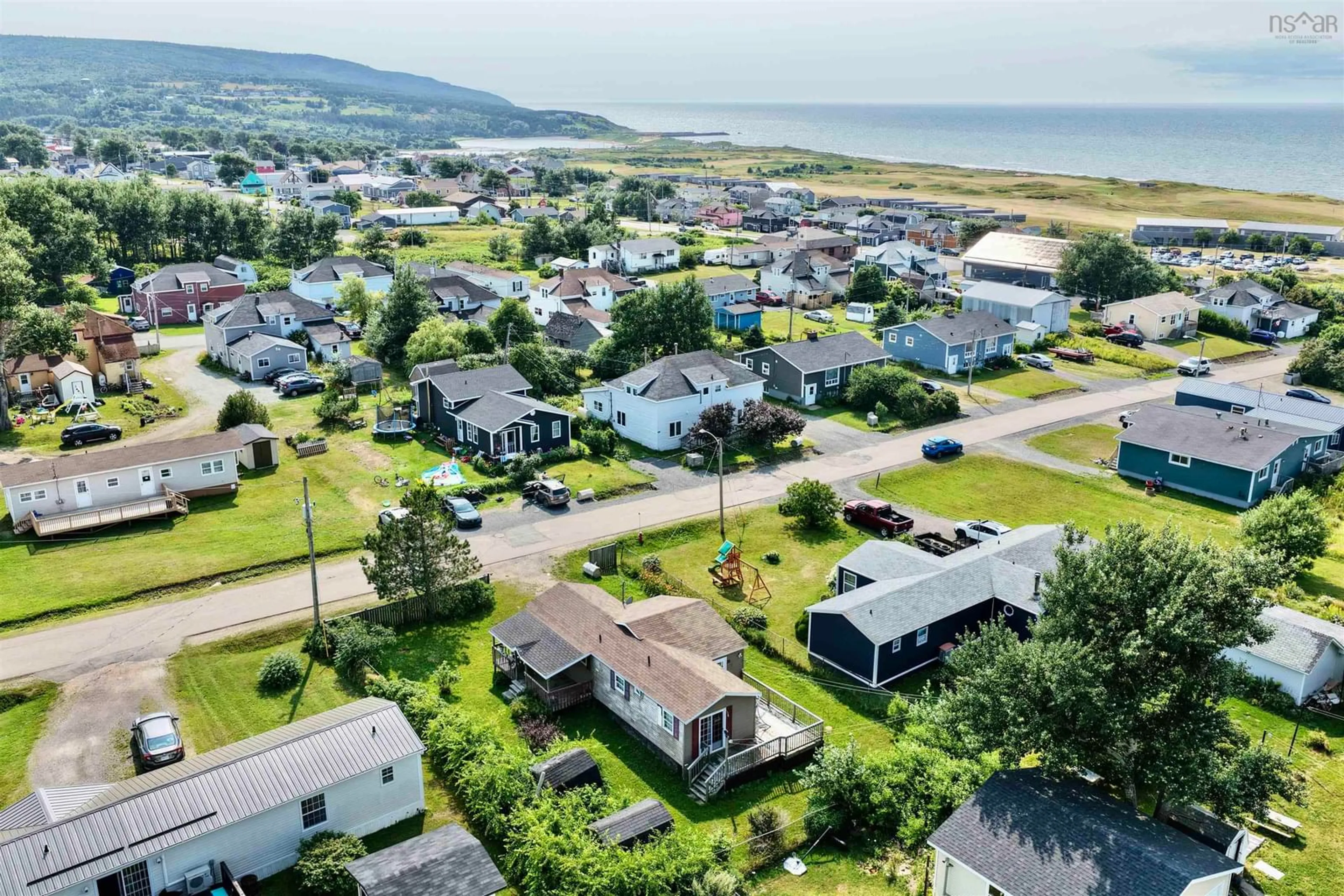 A pic from outside/outdoor area/front of a property/back of a property/a pic from drone, water/lake/river/ocean view for 35 Allan J Memorial Ave, Inverness Nova Scotia B0E 1N0