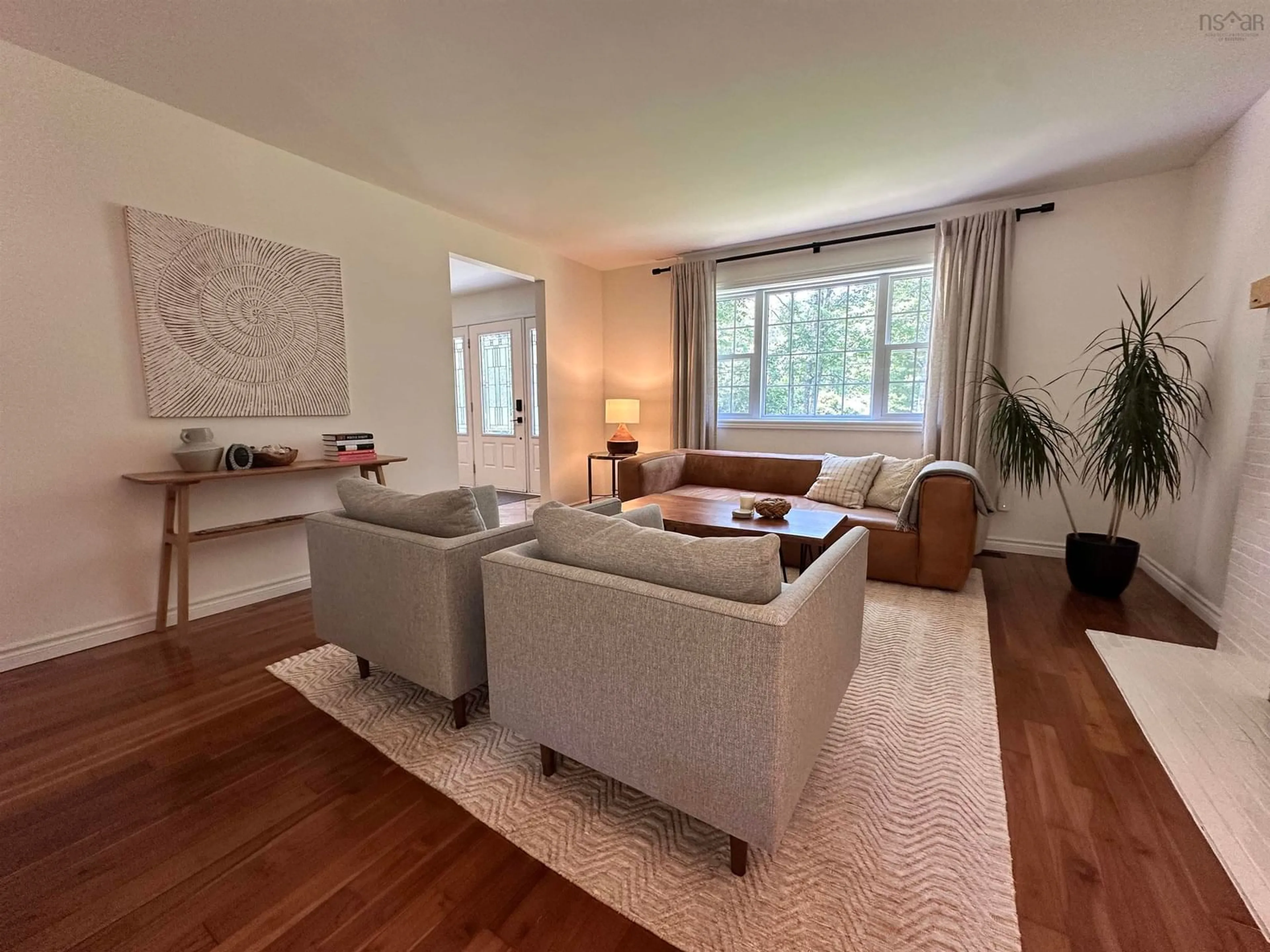 Living room with furniture, wood/laminate floor for 86 Wharf Rock Rd, Mersey Point Nova Scotia B0T 1K0