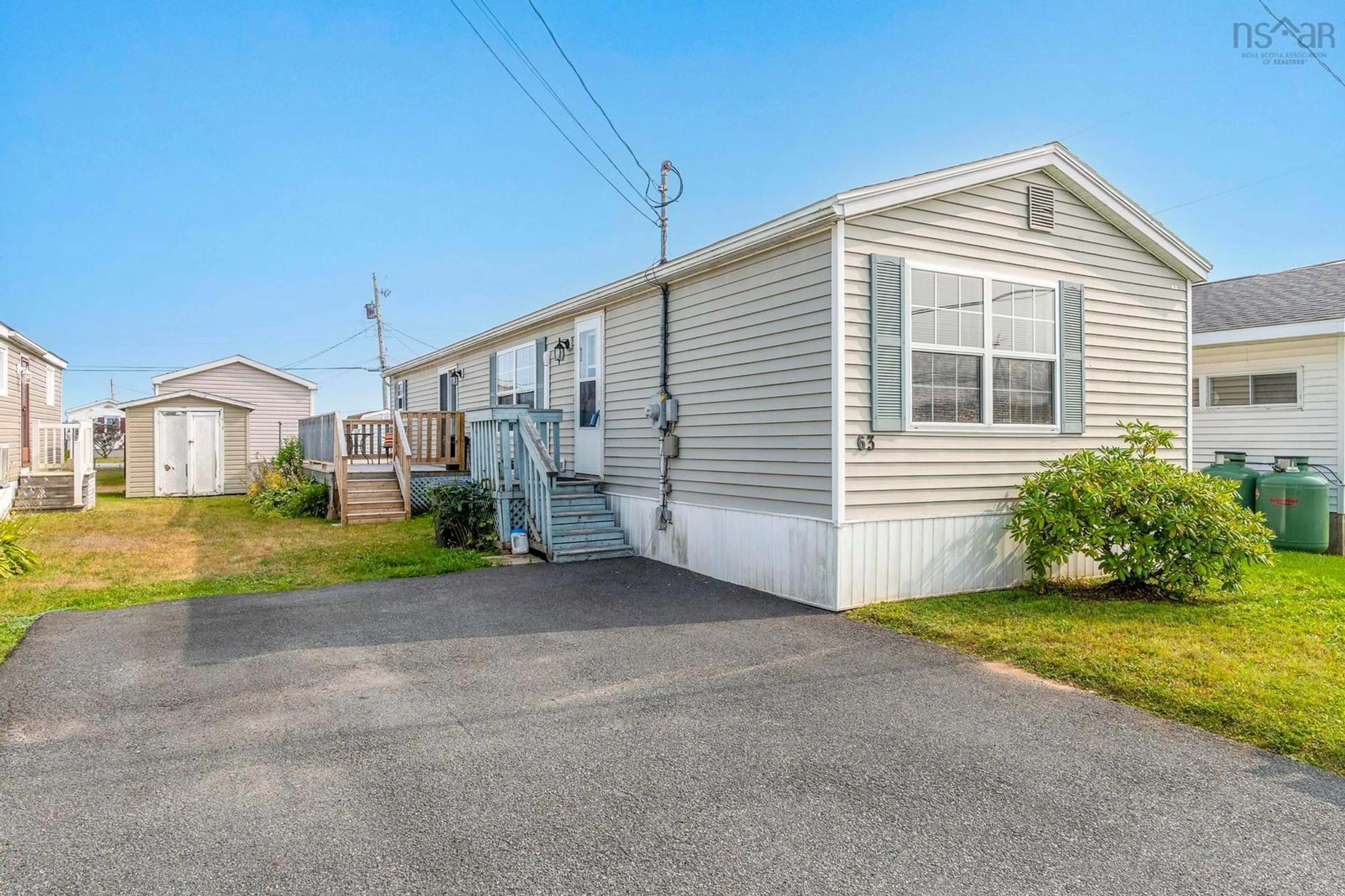 Home with vinyl exterior material, street for 63 That St, Porters Lake Nova Scotia B3E 1H3