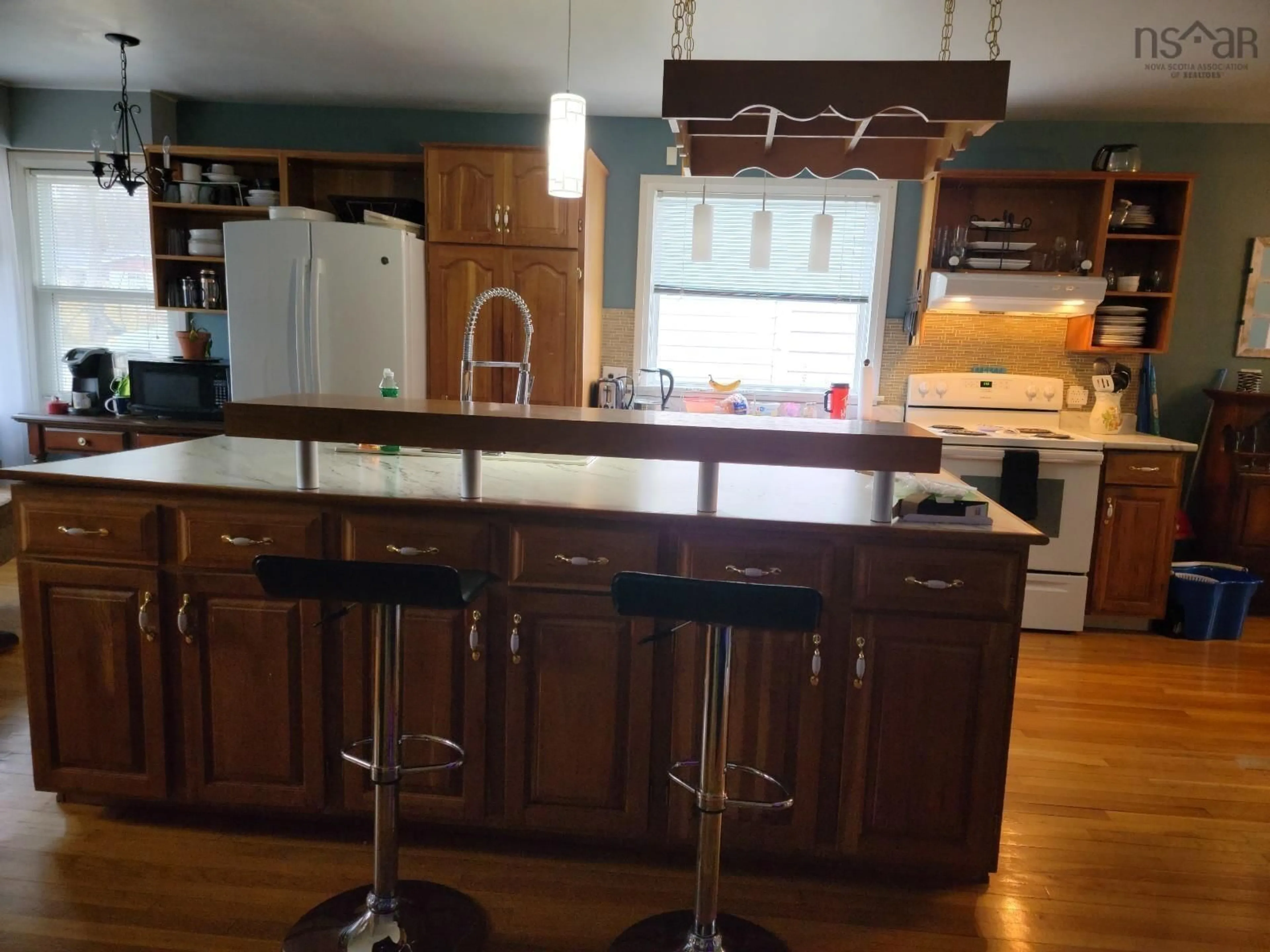 Open concept kitchen, wood/laminate floor for 205 South Bentinck St, Sydney Nova Scotia B1P 1X7