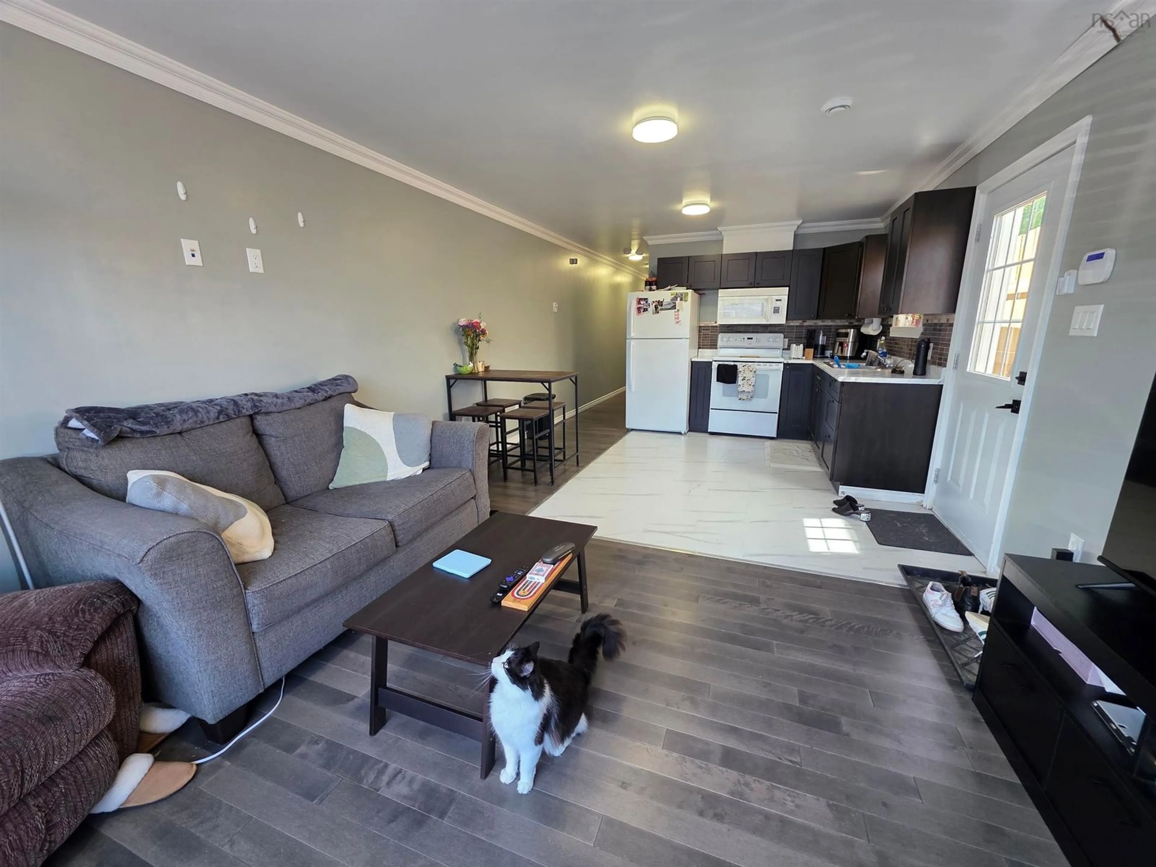 Living room with furniture, wood/laminate floor for 1138 1140 George St, Sydney Nova Scotia B1P 1N2