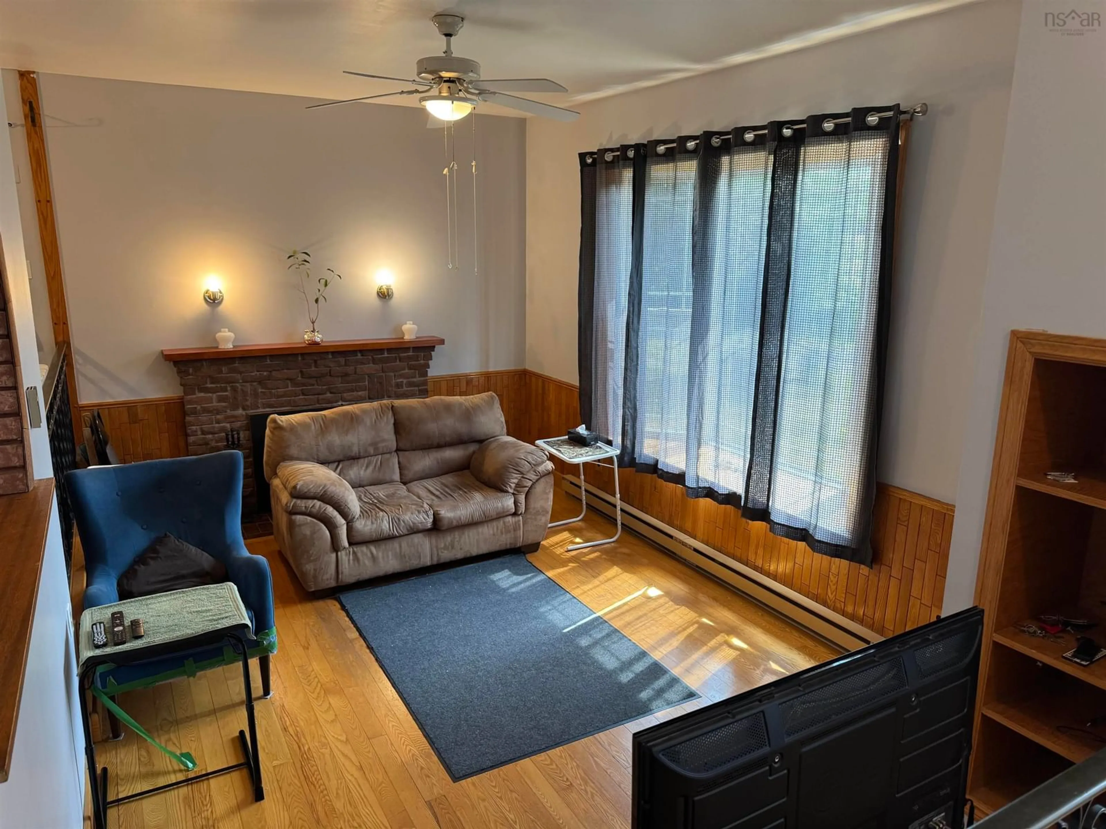 Living room with furniture, wood/laminate floor for 1412 North Main St, Westville Nova Scotia B0K 2A0