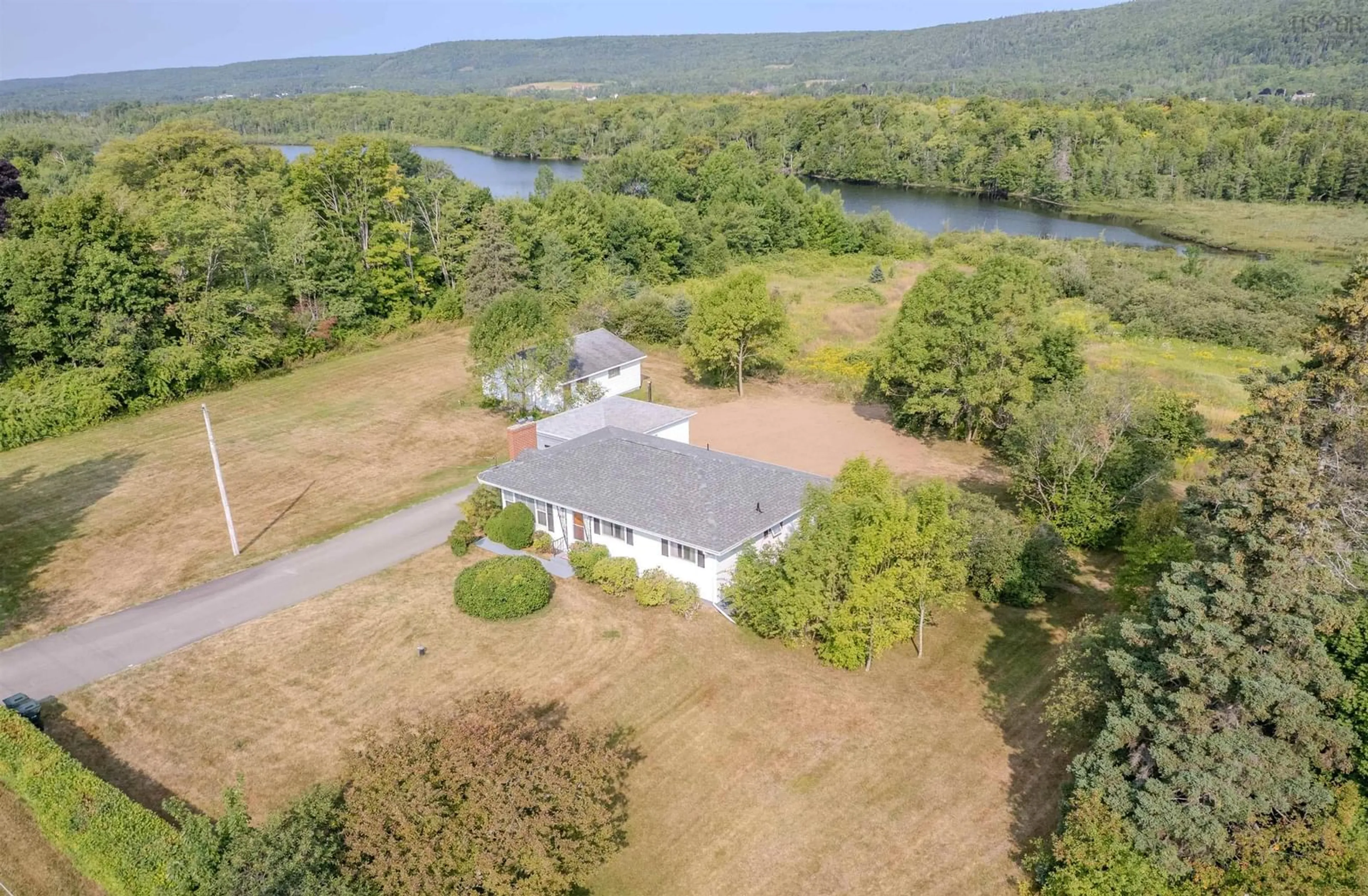 A pic from outside/outdoor area/front of a property/back of a property/a pic from drone, water/lake/river/ocean view for 2450 Kings Rd, Sydney Forks Nova Scotia B1L 1A1