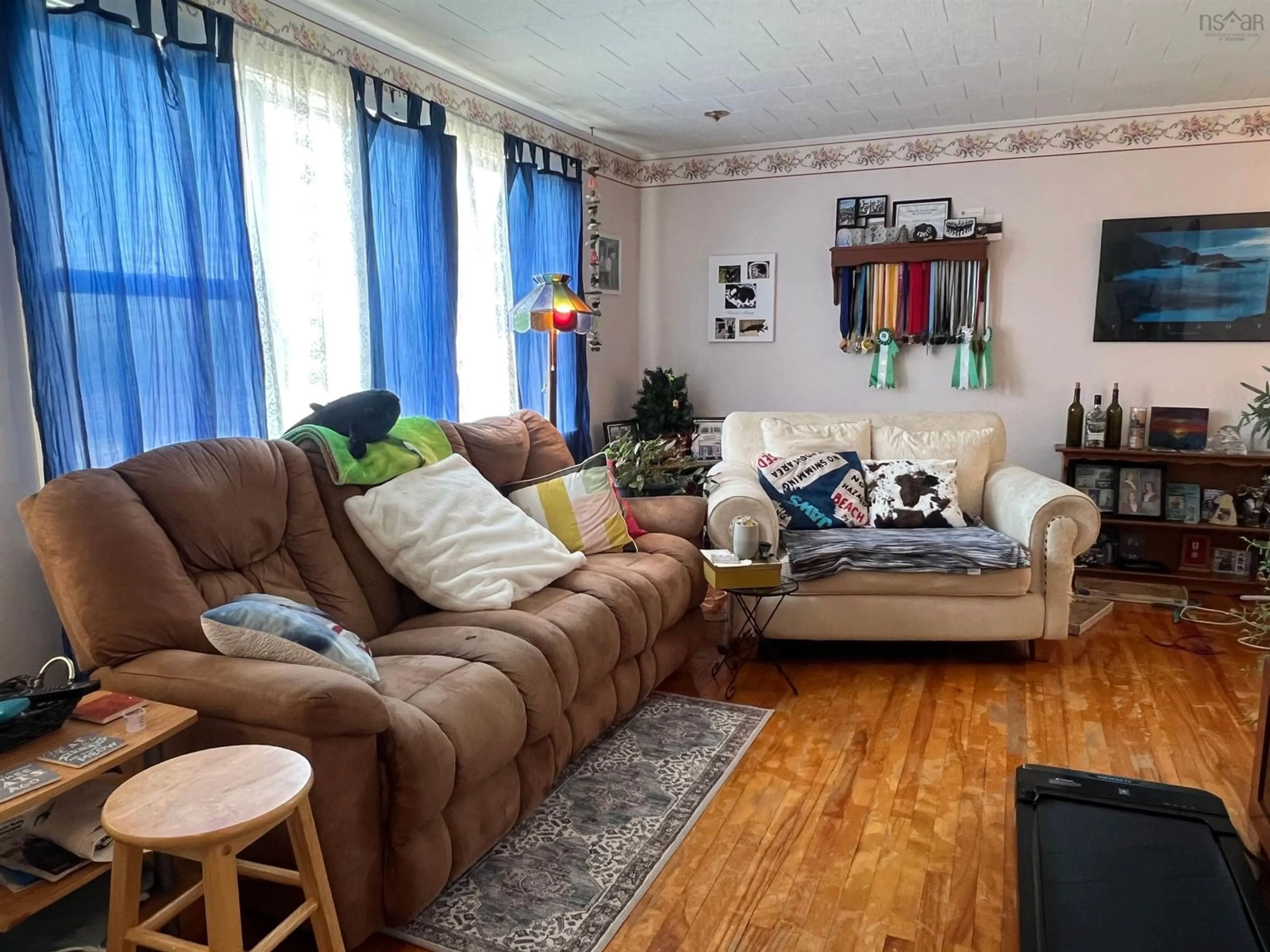 Living room with furniture, wood/laminate floor for 68 Hibernia St, Yarmouth Nova Scotia B5A 2M6
