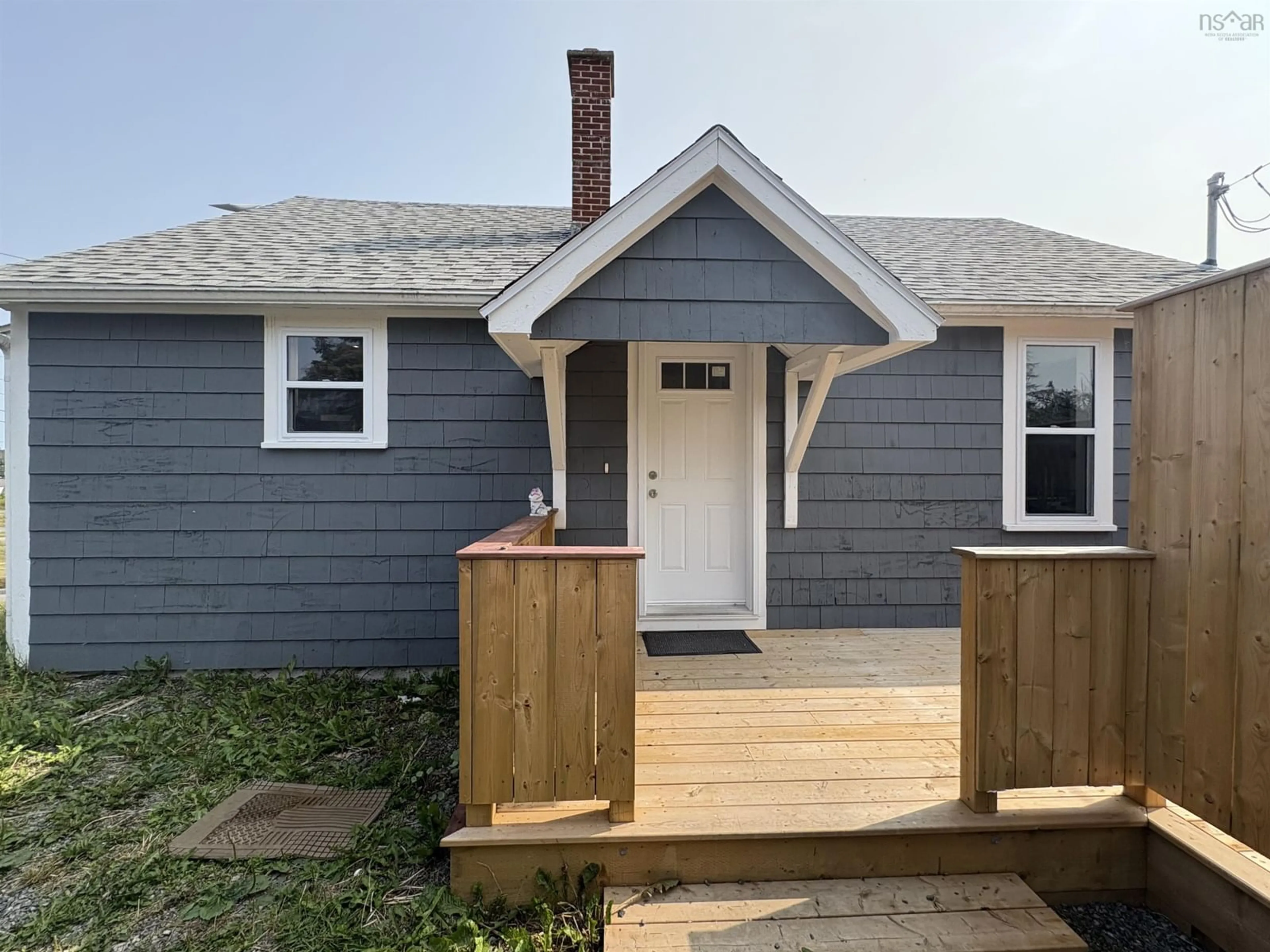 Home with vinyl exterior material, street for 21 Marconi St, Louisbourg Nova Scotia B1C 1K2