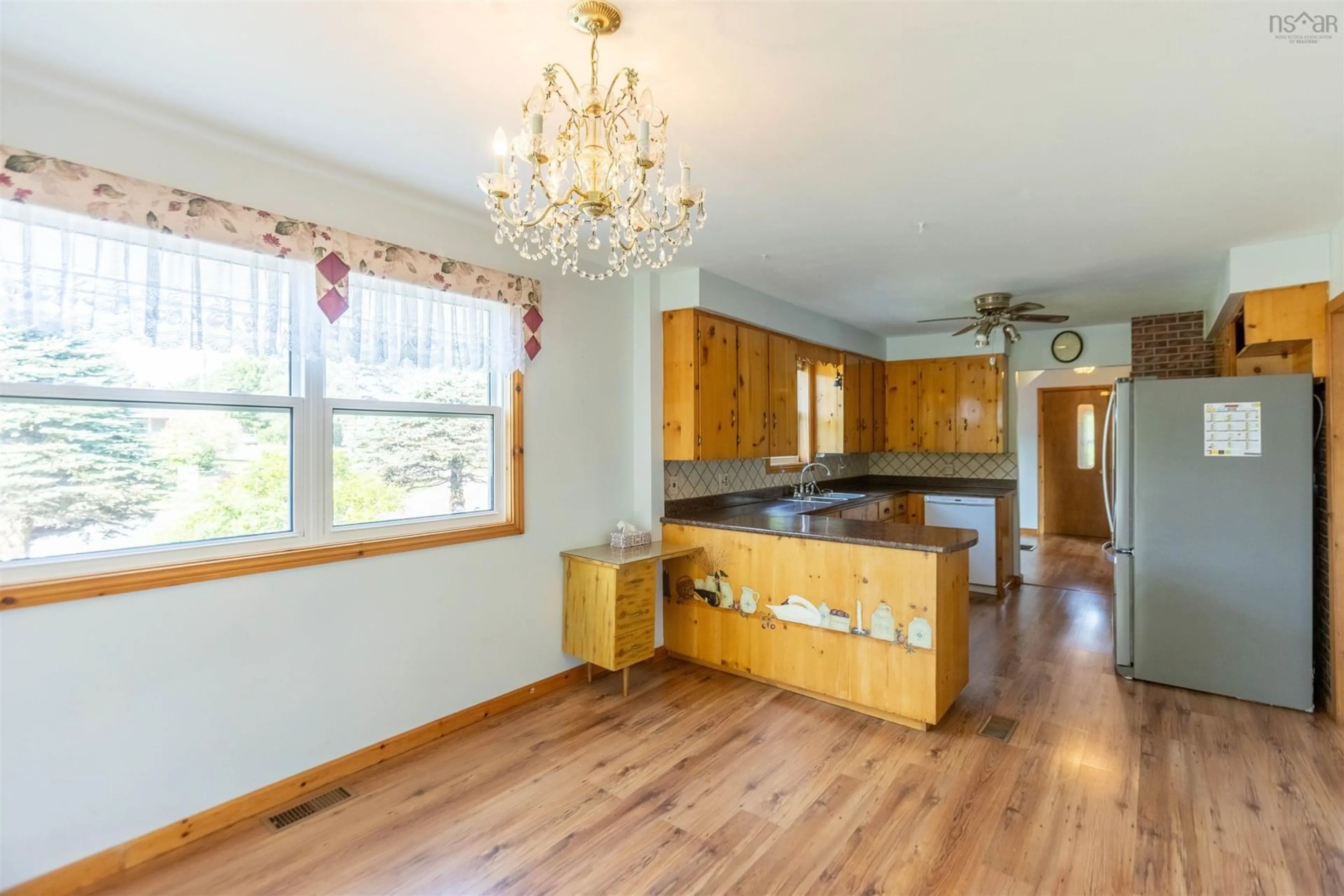 Open concept kitchen, wood/laminate floor for 46 Cornwall St, Amherst Nova Scotia B4H 2L4