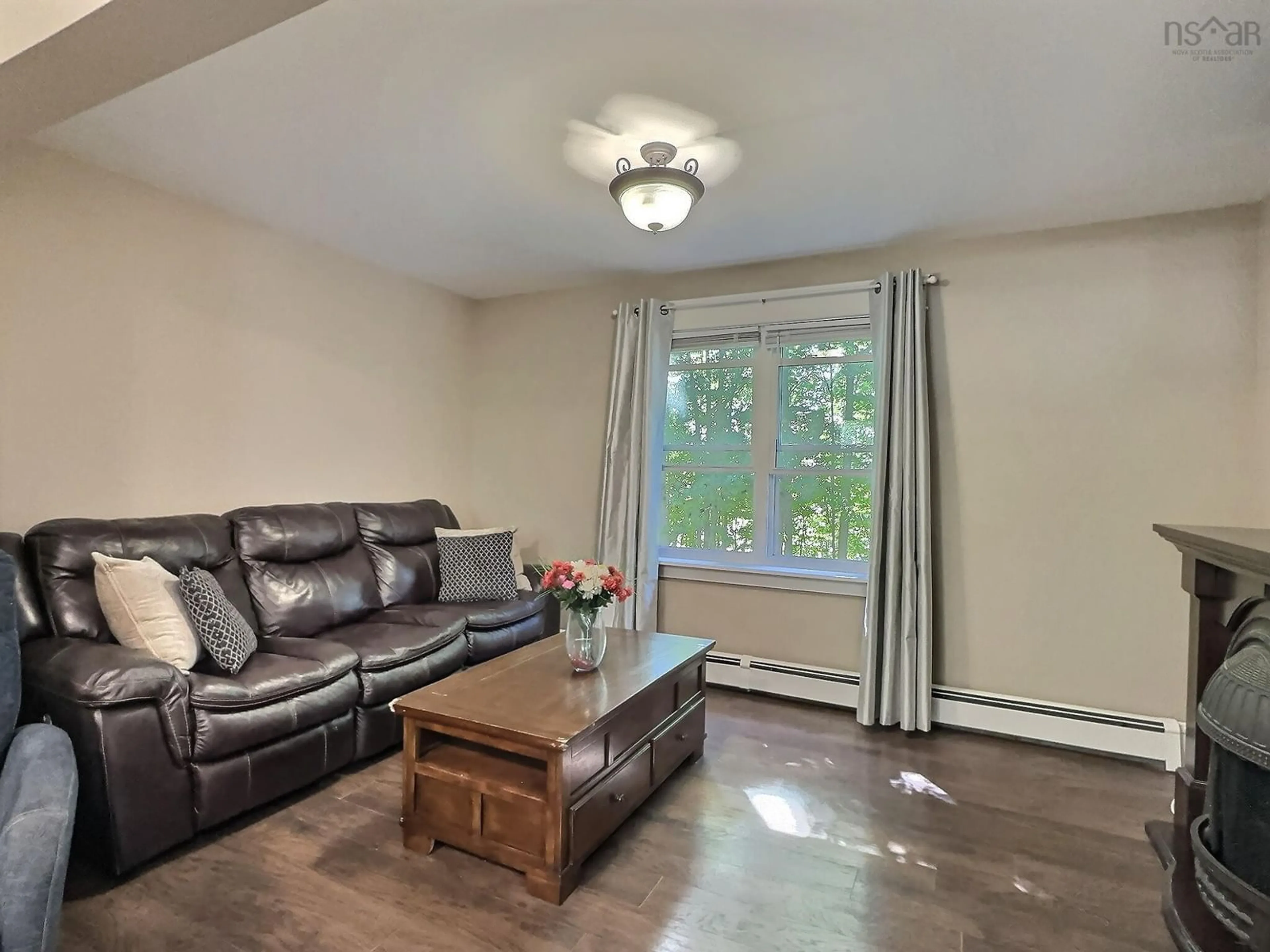 Living room with furniture, wood/laminate floor for 1341 East Prince St, Truro Nova Scotia B2N 1J5