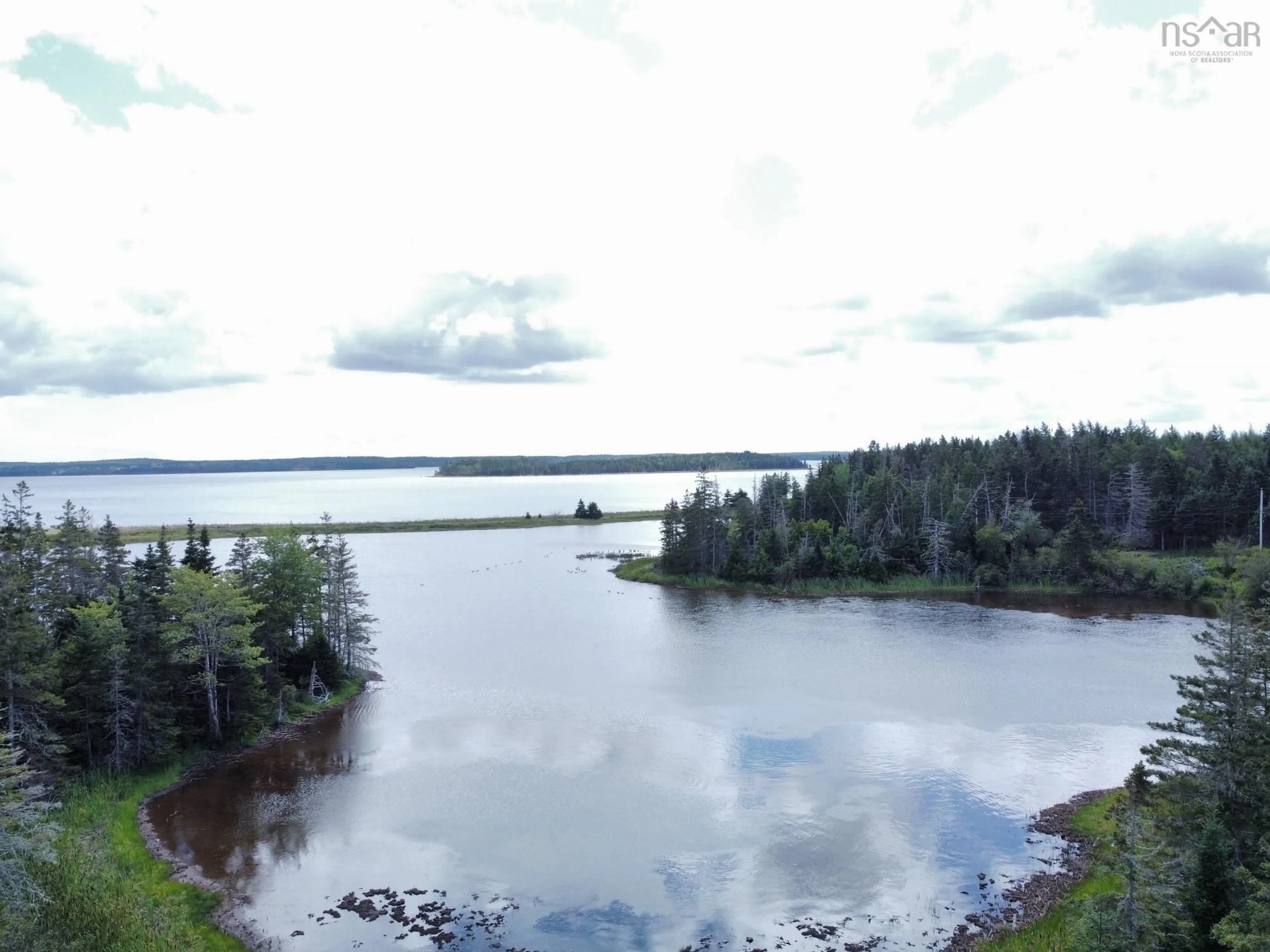 A pic from outside/outdoor area/front of a property/back of a property/a pic from drone, water/lake/river/ocean view for 311 Richards Pond Rd, River Bourgeois Nova Scotia B0E 2X0
