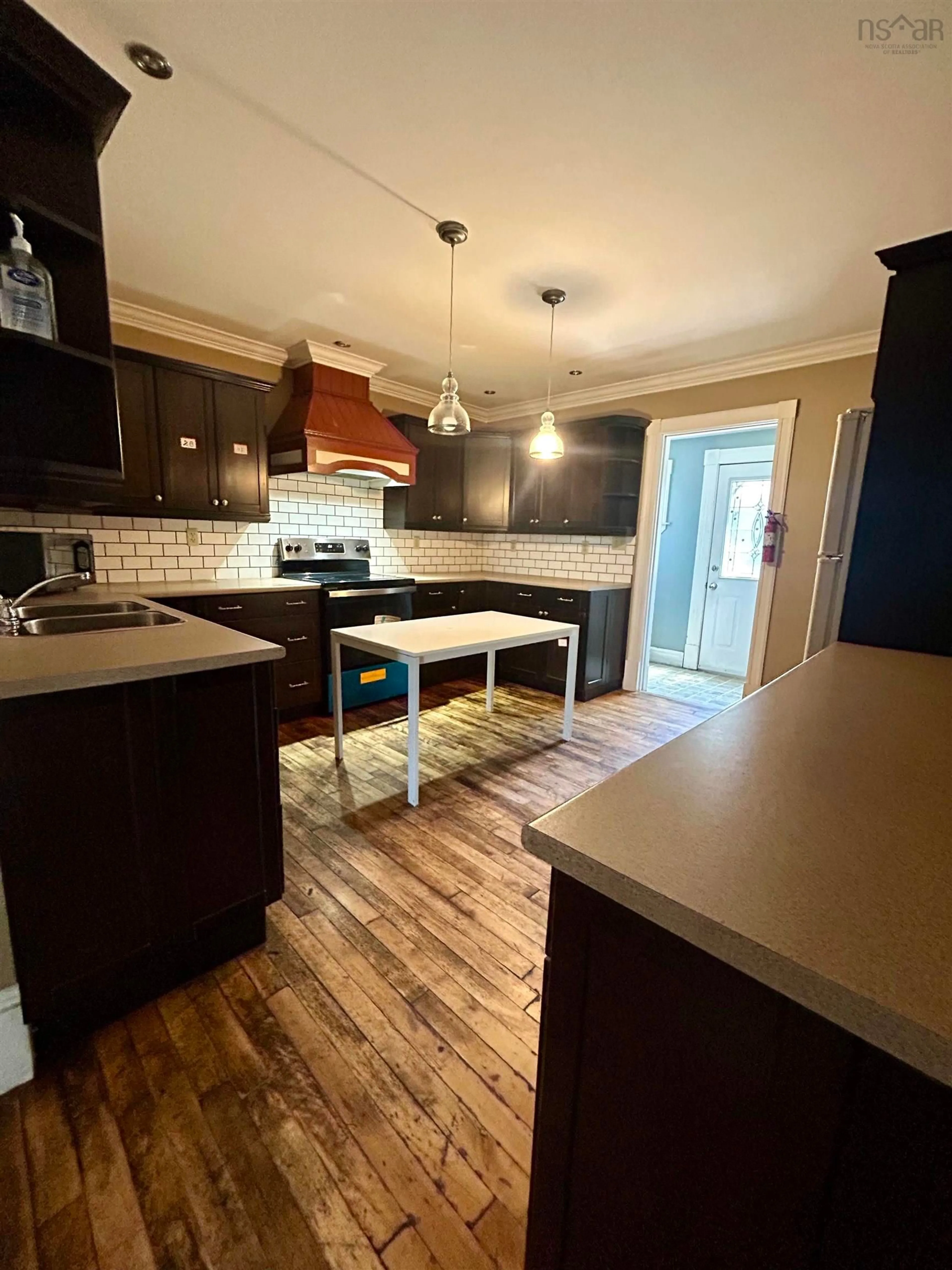 Open concept kitchen, wood/laminate floor for 346 Townsend St., Sydney Nova Scotia B1P 5G2