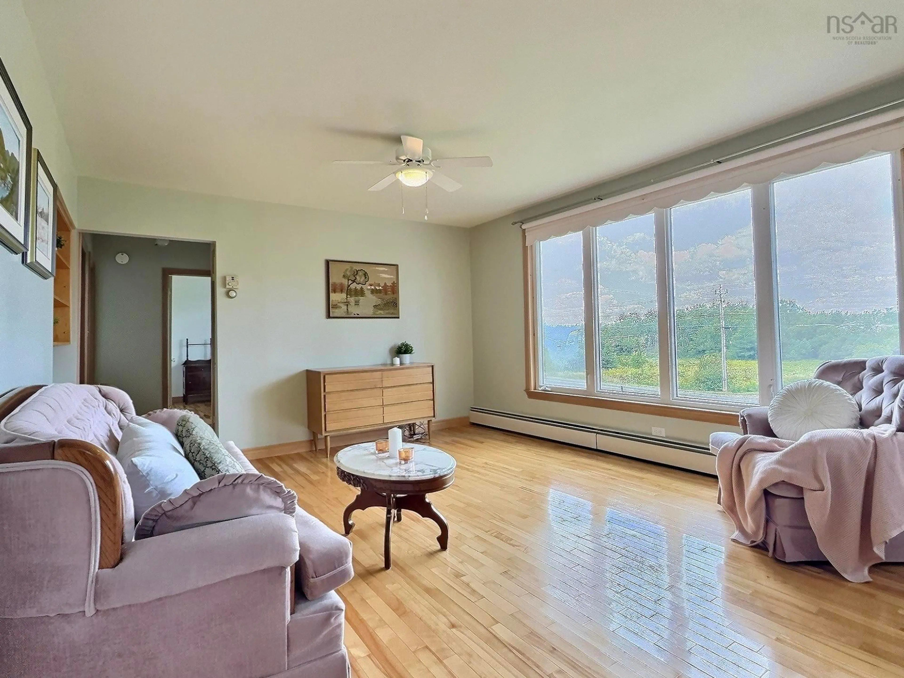 Living room with furniture, wood/laminate floor for 902 Cheticamp Back Rd, Belle Marche Nova Scotia B0E 1H0