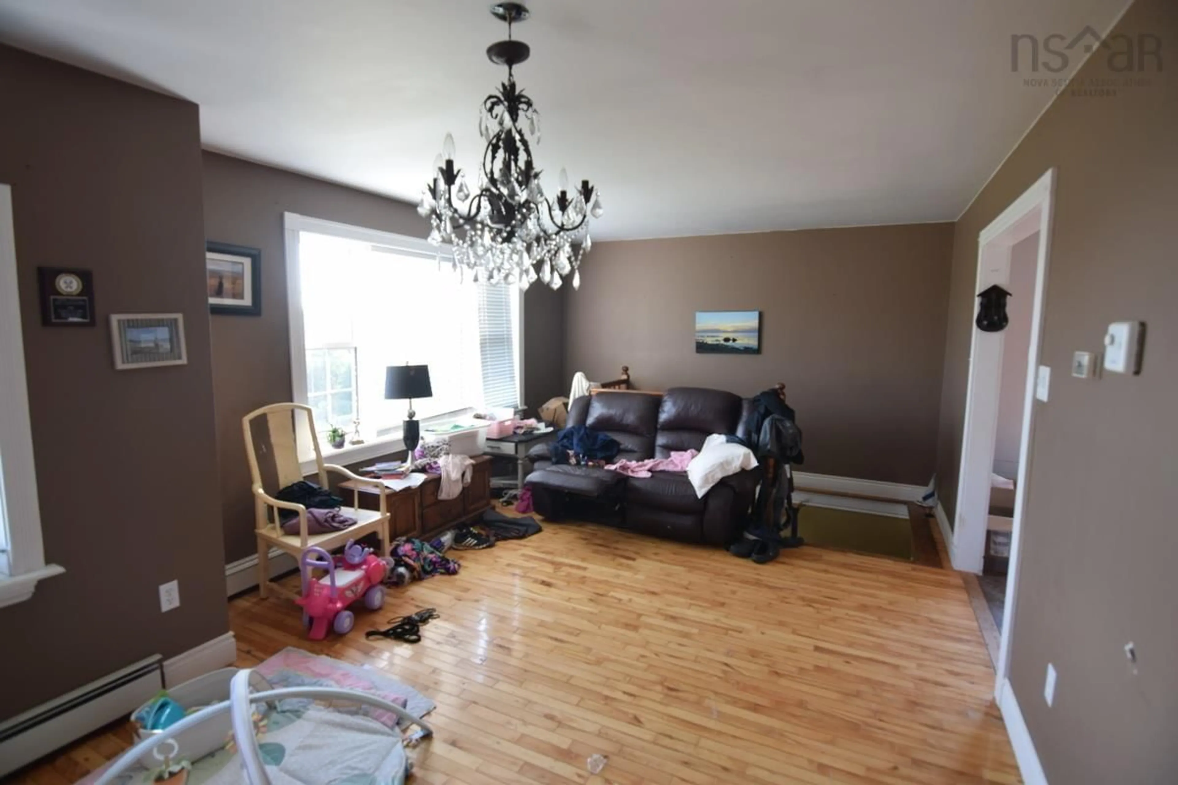 Living room with furniture, wood/laminate floor for 121 Campbellton Rd, Inverness Nova Scotia B0E 1N0