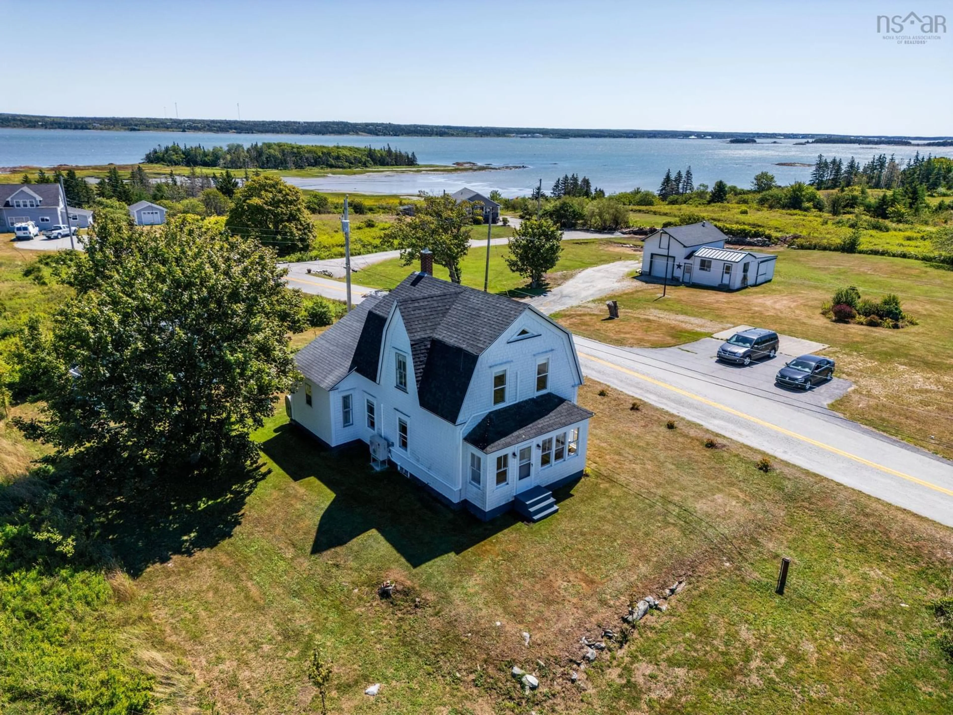 A pic from outside/outdoor area/front of a property/back of a property/a pic from drone, water/lake/river/ocean view for 21 Sams Rd, West Pubnico Nova Scotia B0W 3S0