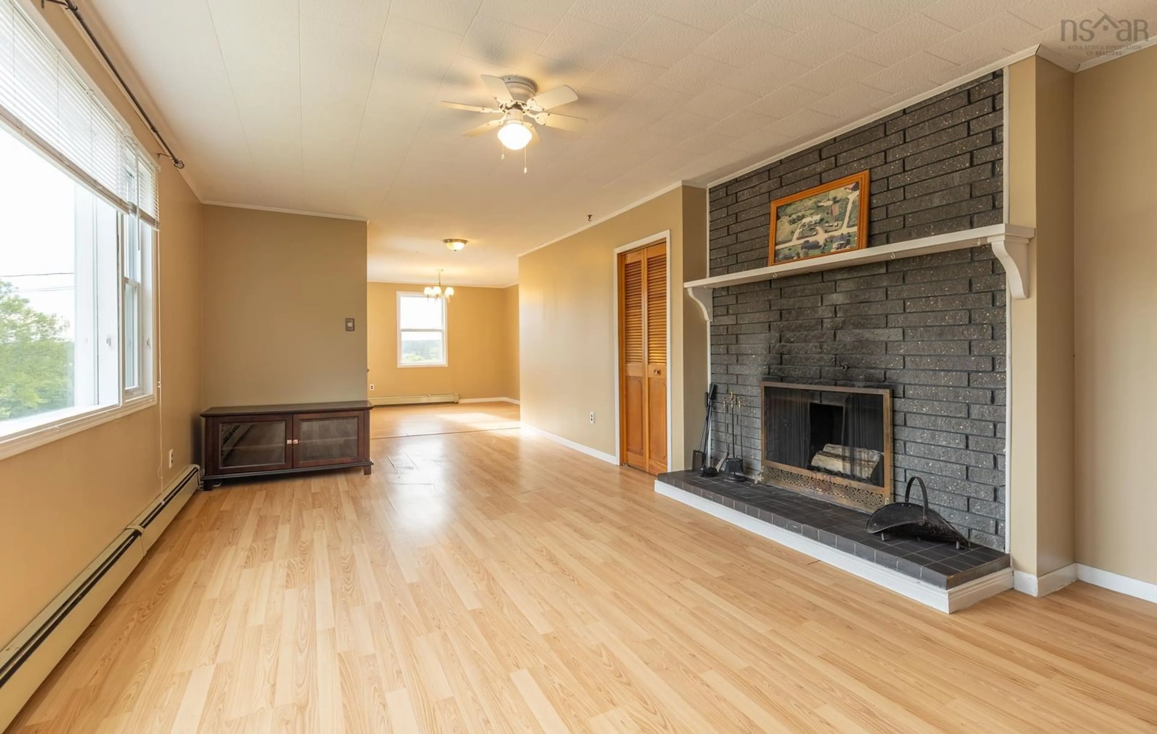 Living room with furniture, wood/laminate floor for 721 Wyman Rd, Sand Beach Nova Scotia B5A 5G4