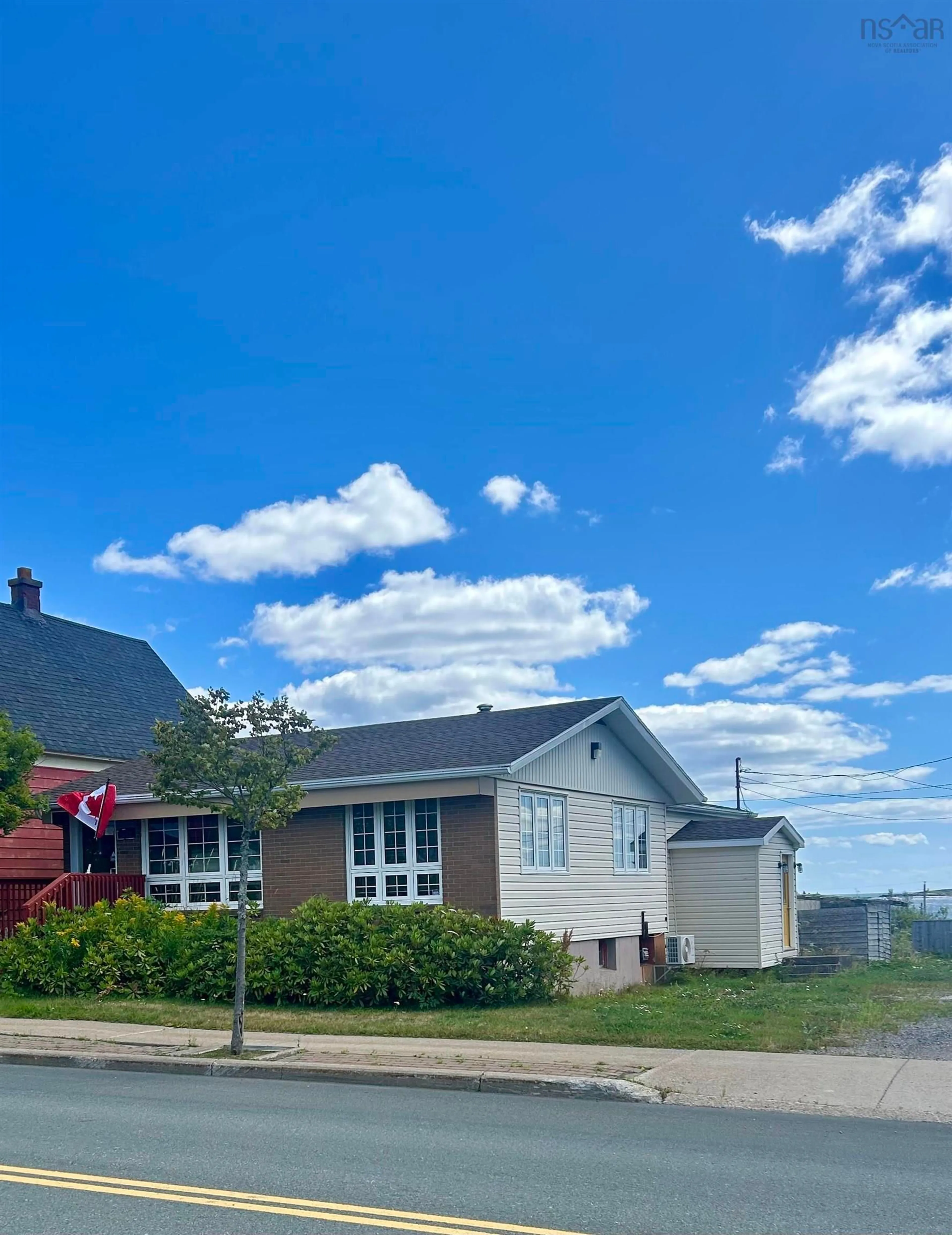 A pic from outside/outdoor area/front of a property/back of a property/a pic from drone, street for 7561 Main St., Louisbourg Nova Scotia B1C 1J7