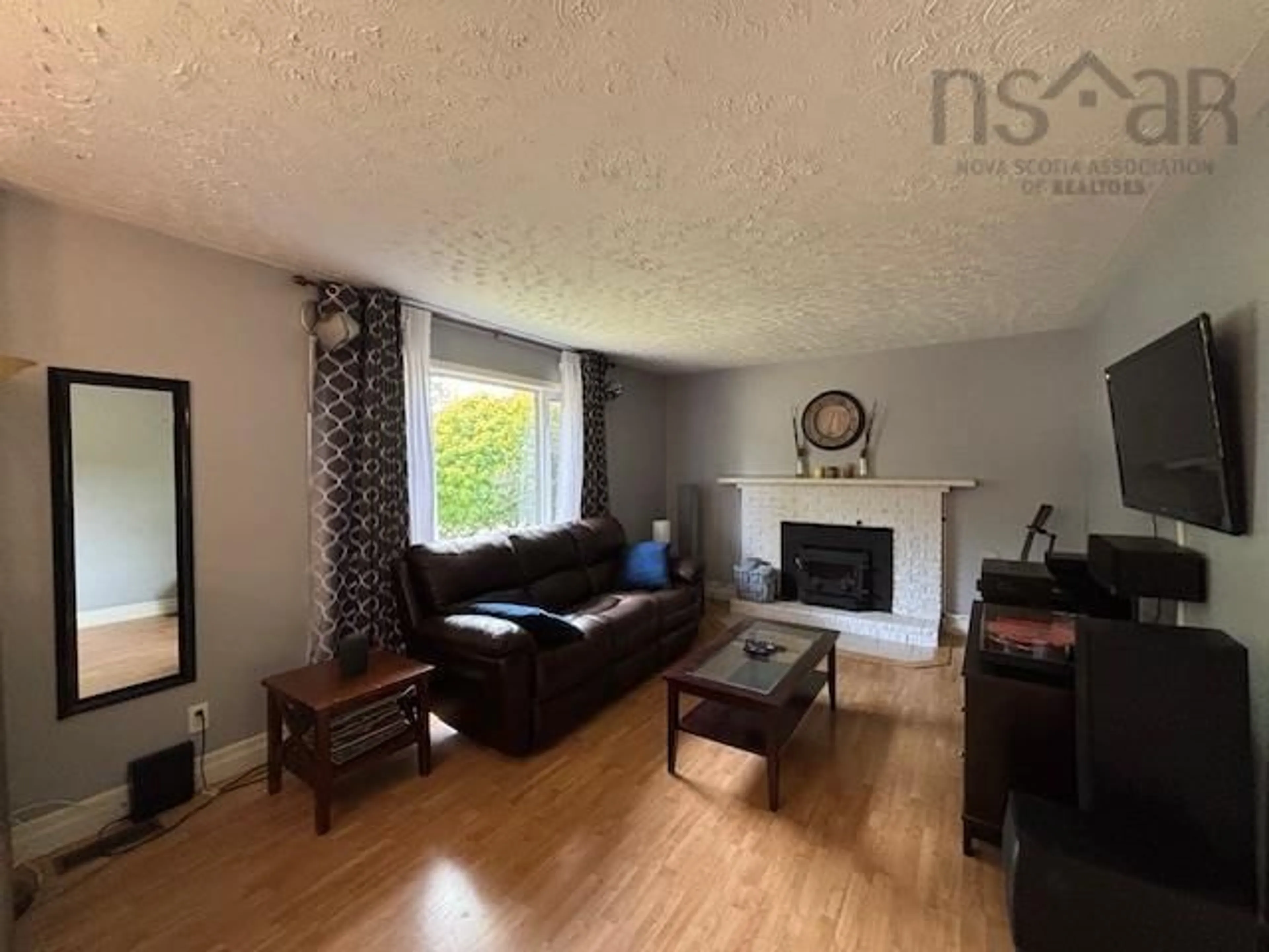 Living room with furniture, wood/laminate floor for 3196 Highway 325, Wileville Nova Scotia B4V 5G7