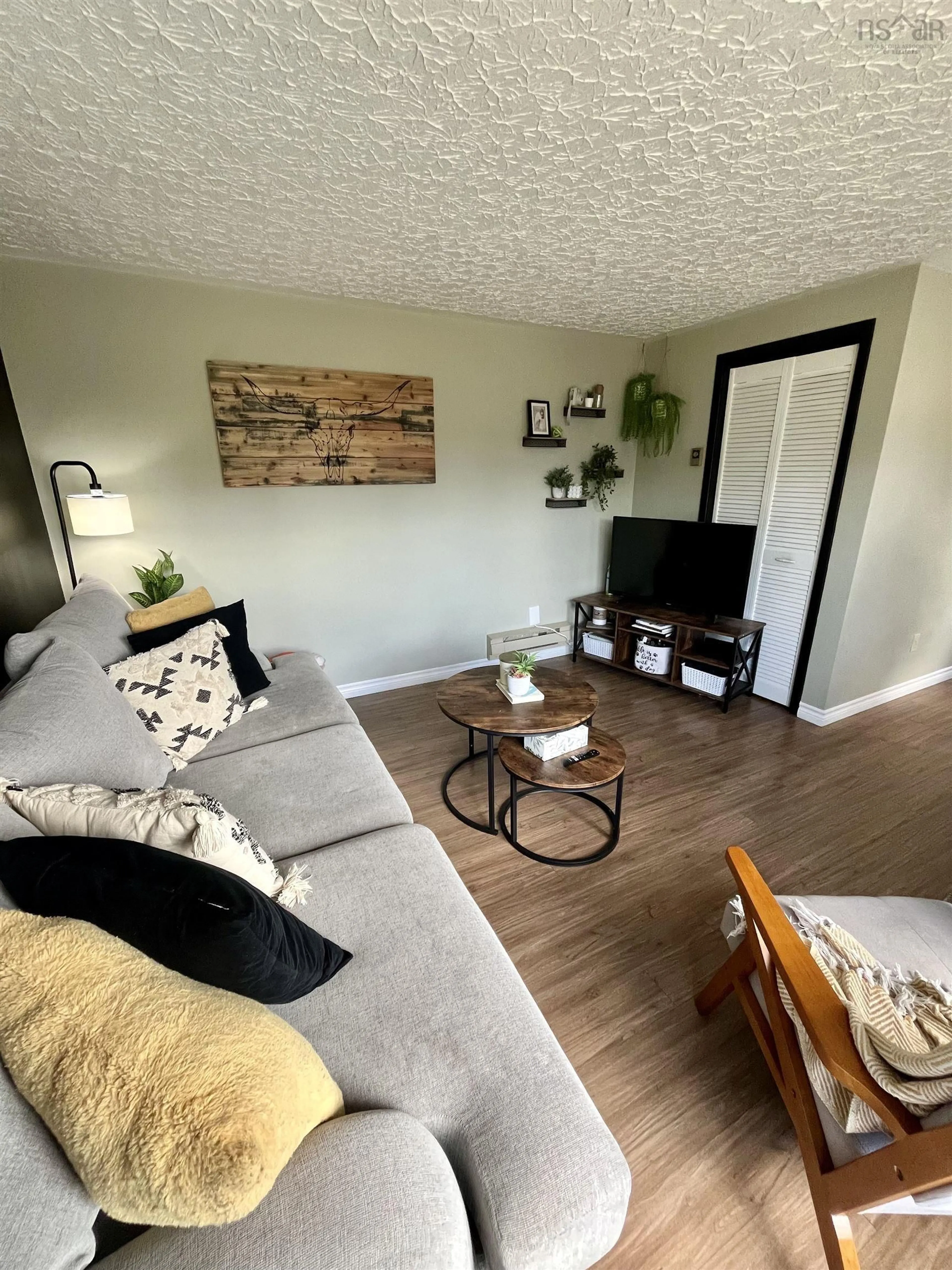 Living room with furniture, wood/laminate floor for 72 Acadia Ave, Stellarton Nova Scotia B0K 1S0