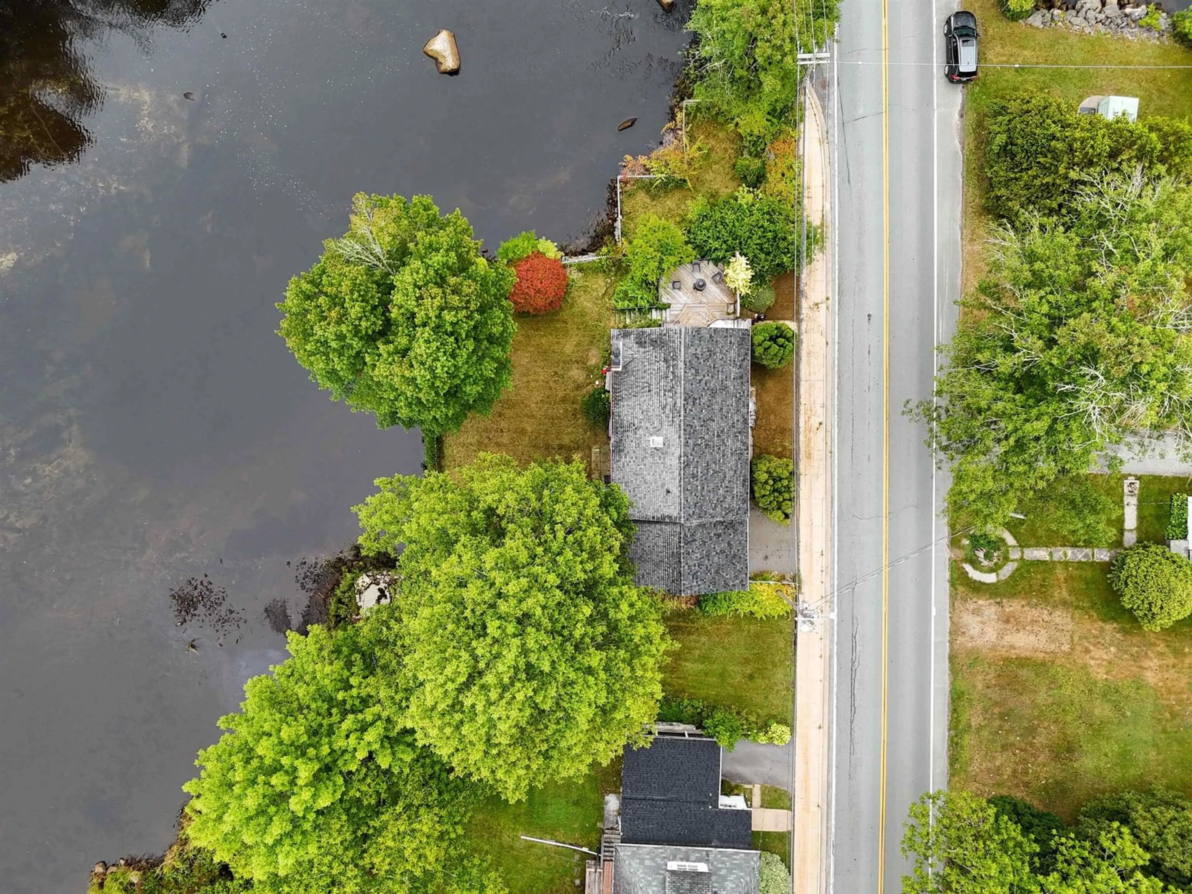 A pic from outside/outdoor area/front of a property/back of a property/a pic from drone, water/lake/river/ocean view for 233 Highway 8, Milton Nova Scotia B0T 1P0
