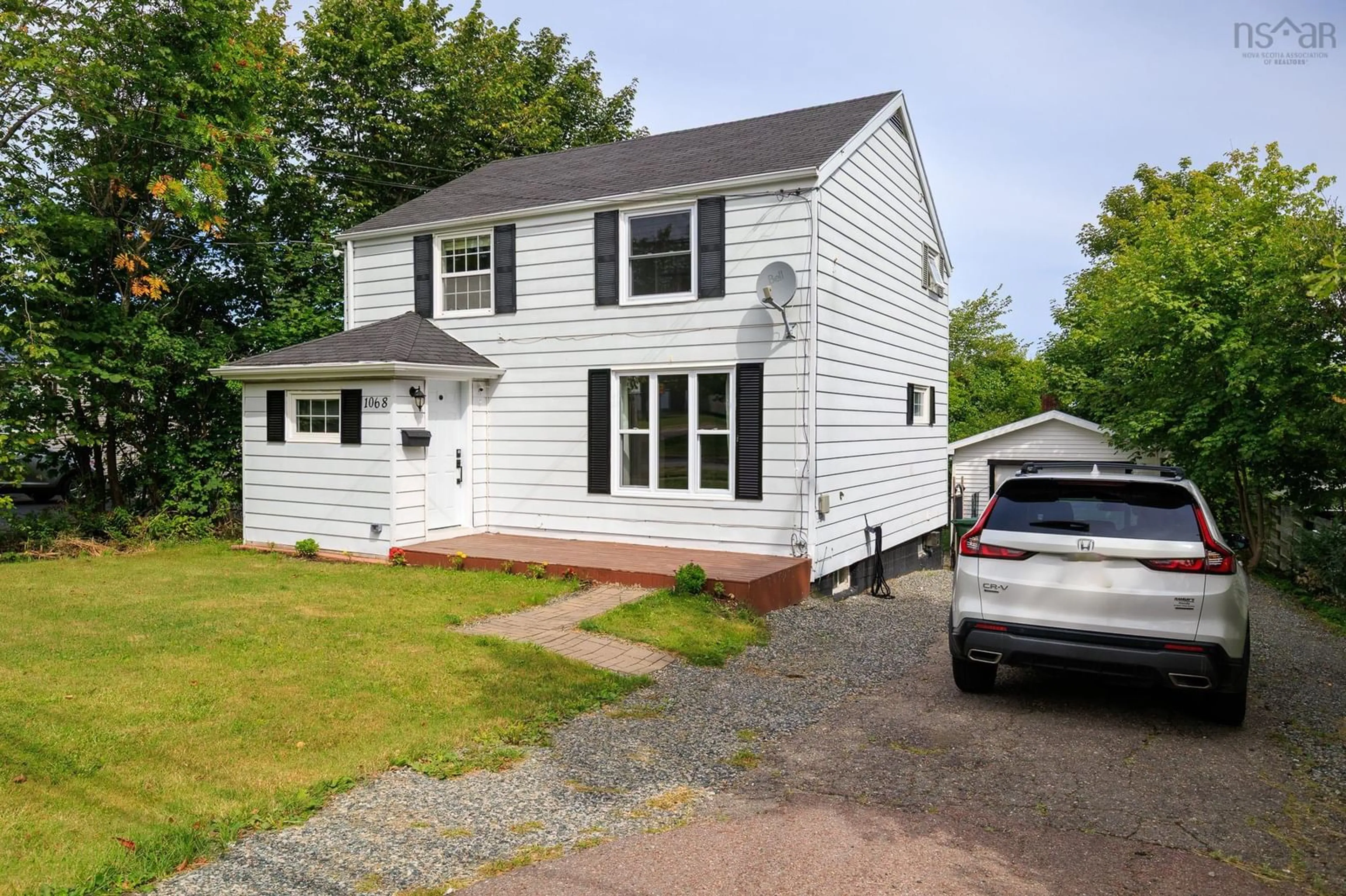 Home with vinyl exterior material, street for 1068 Main Street, Glace Bay Nova Scotia B1A 4Z7