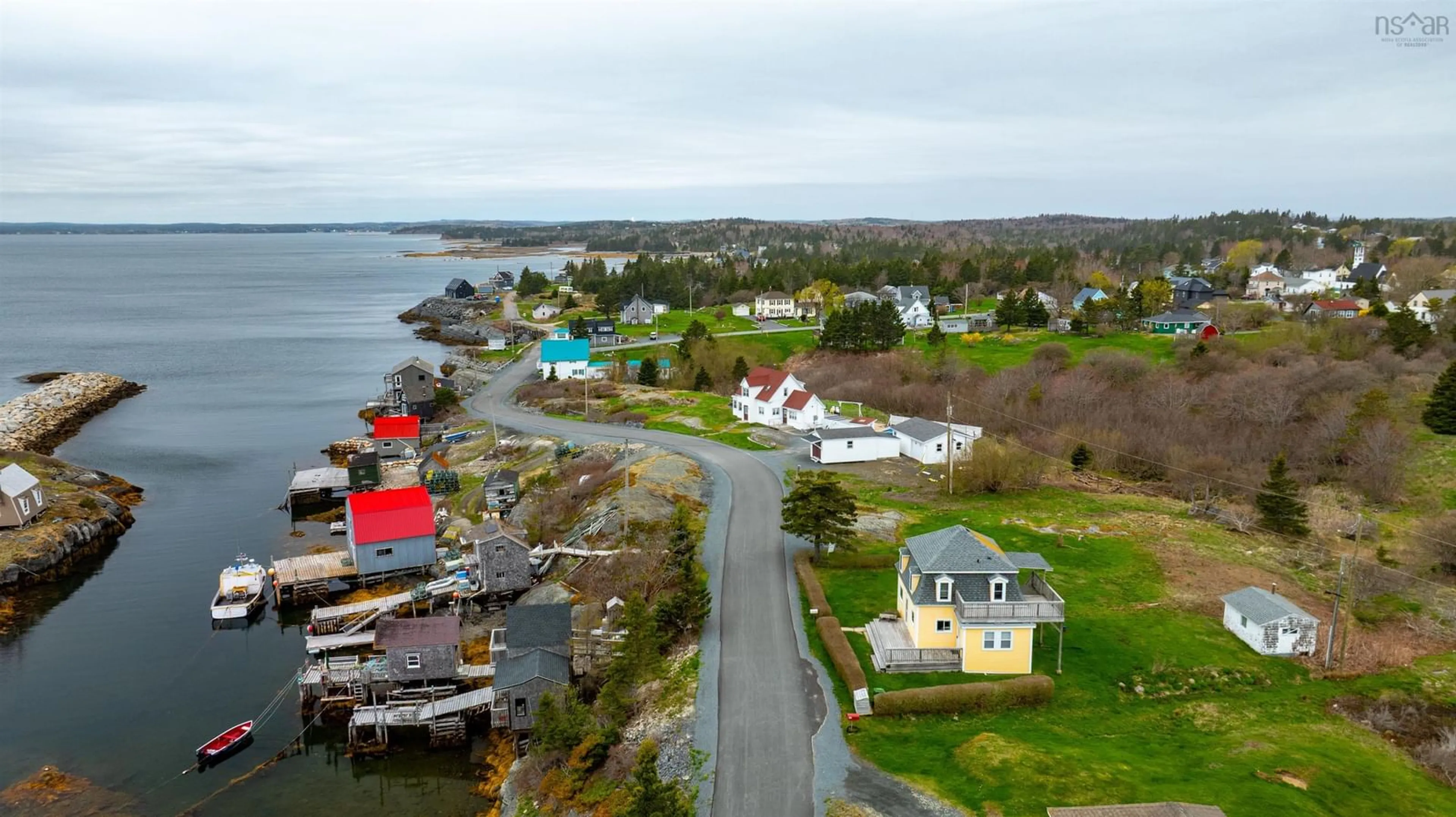 A pic from outside/outdoor area/front of a property/back of a property/a pic from drone, water/lake/river/ocean view for 125 The Point Rd, Blue Rocks Nova Scotia B0J 2C0