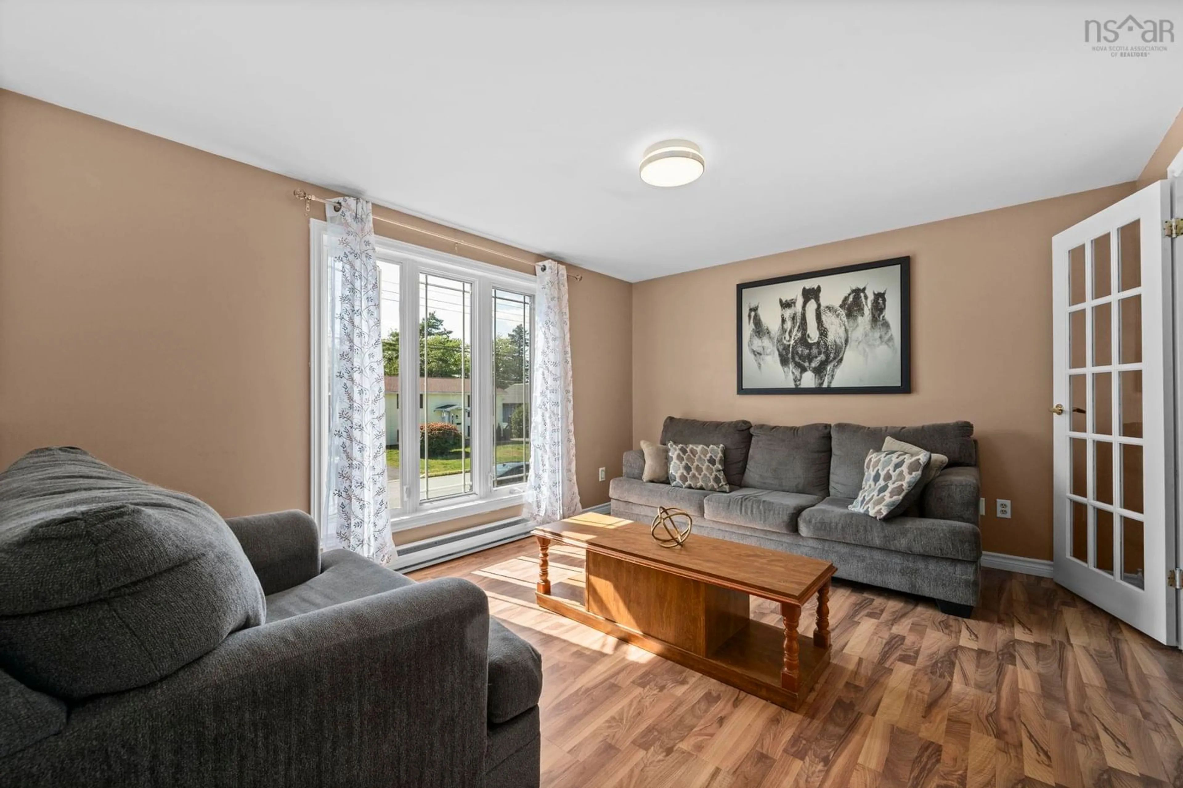 Living room with furniture, wood/laminate floor for 85 Cartier Cres, Lower Sackville Nova Scotia B4C 3K8
