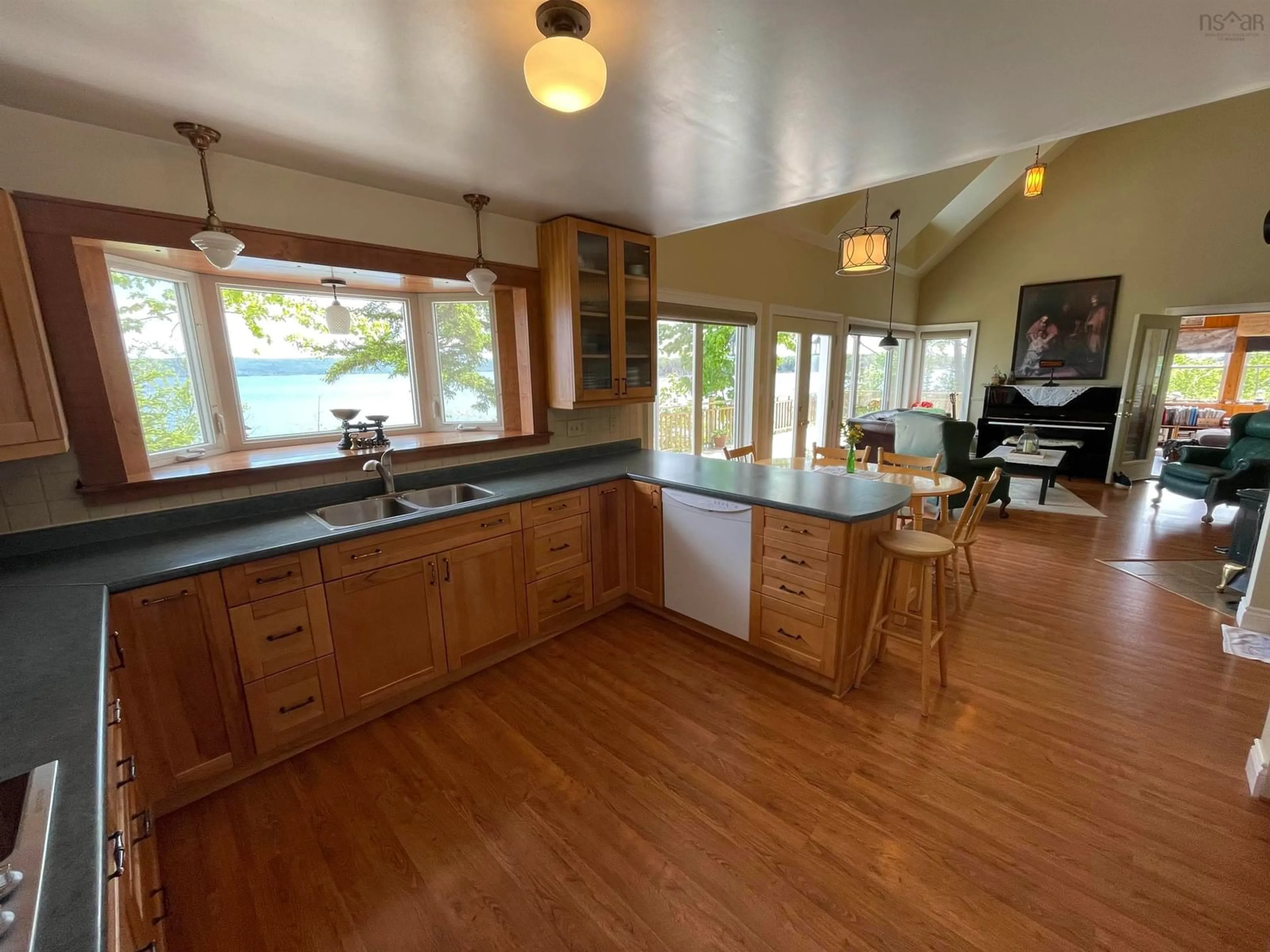 Open concept kitchen, wood/laminate floor for 5067 Kempt Head Rd, Southside Boularderie Nova Scotia B1Y 2P3
