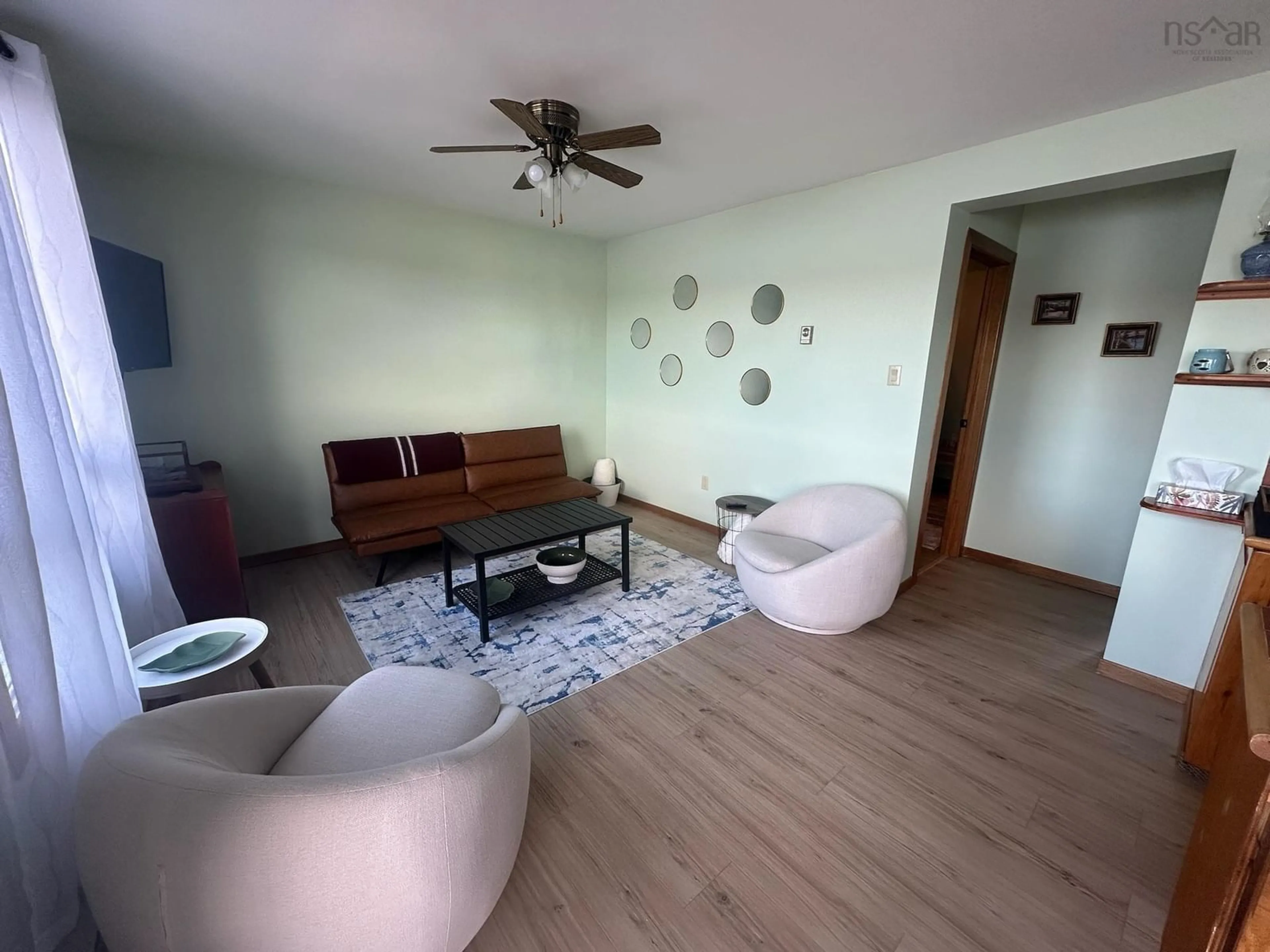 Living room with furniture, wood/laminate floor for 2230 Larrys River Rd, Lundy Nova Scotia B0H 1N0