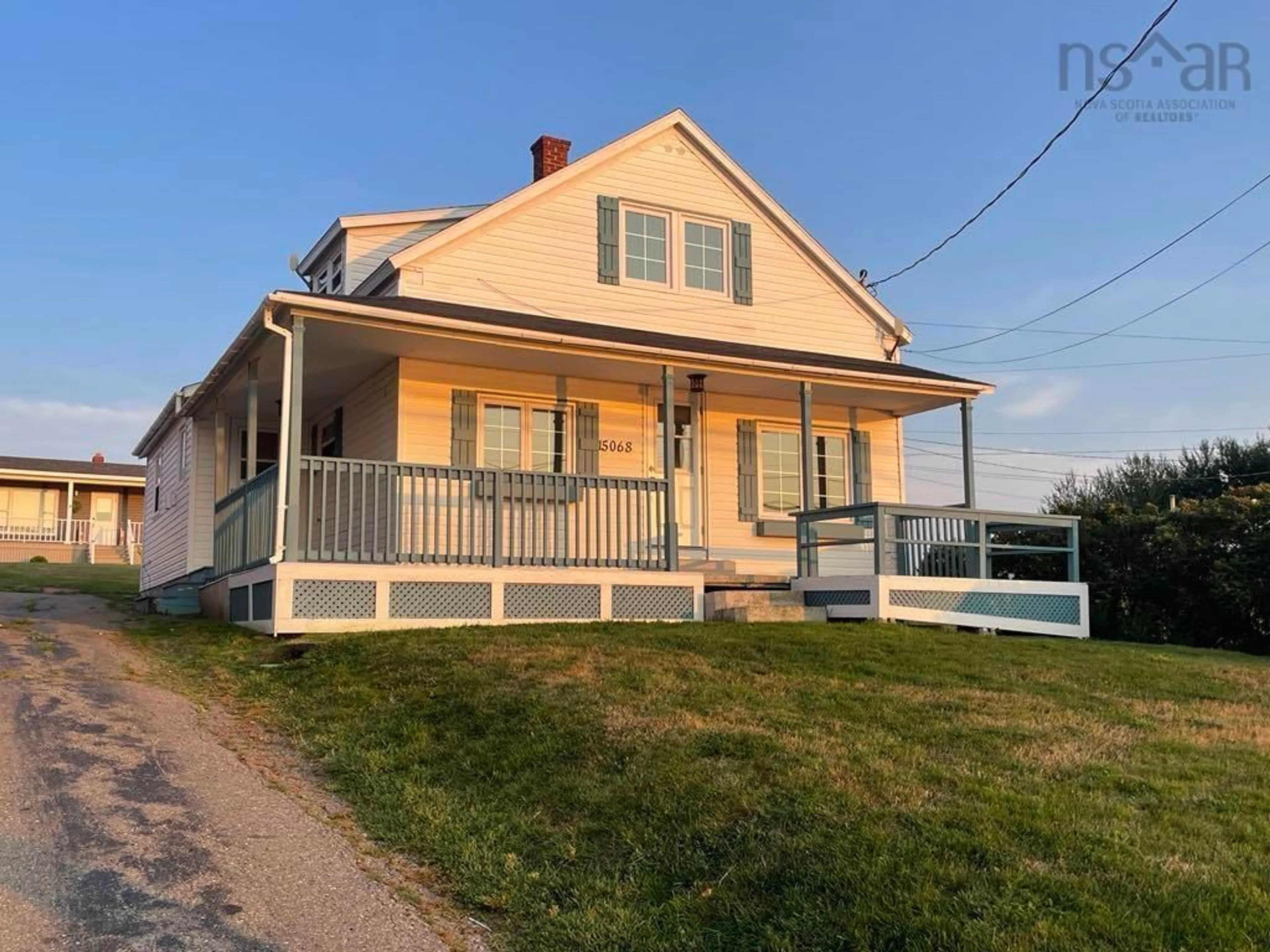 Home with vinyl exterior material, street for 15068 Cabot Trail, Chéticamp Nova Scotia B0E 1H0