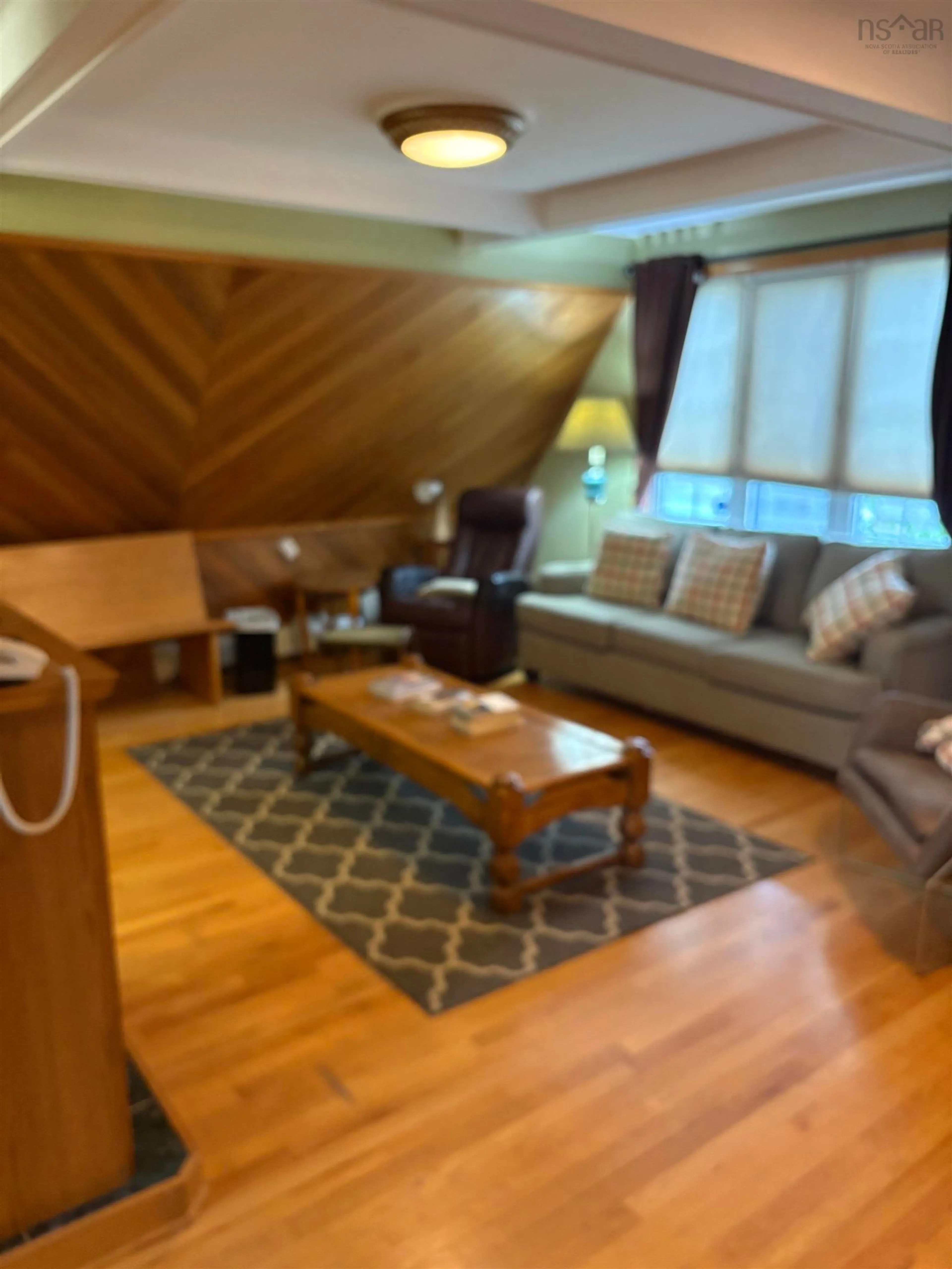 Living room with furniture, wood/laminate floor for 1398 George St, Mira Road Nova Scotia B1P 1N2
