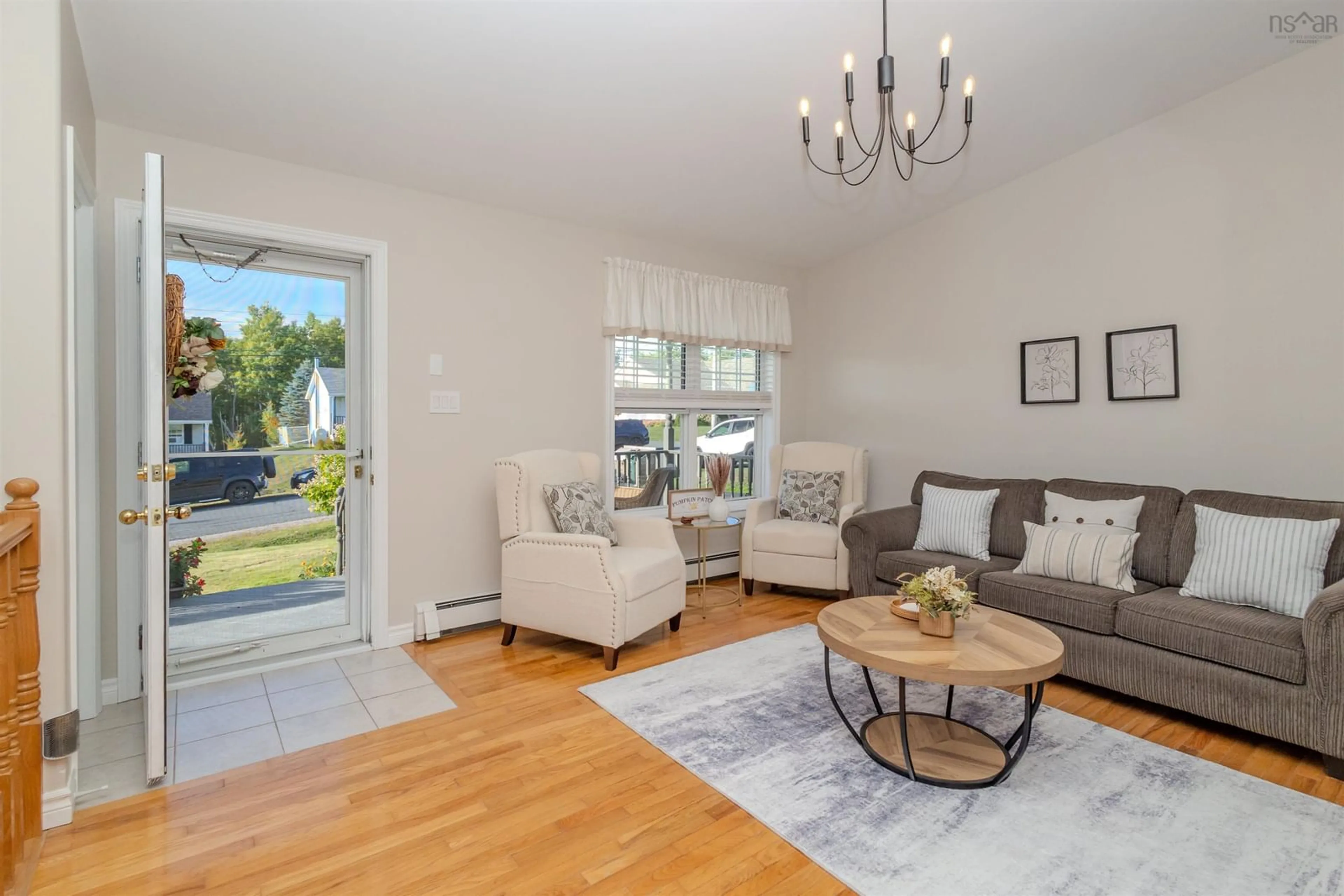 Living room with furniture, wood/laminate floor for 63 Mae Ave, Sydney Mines Nova Scotia B1V 3K8