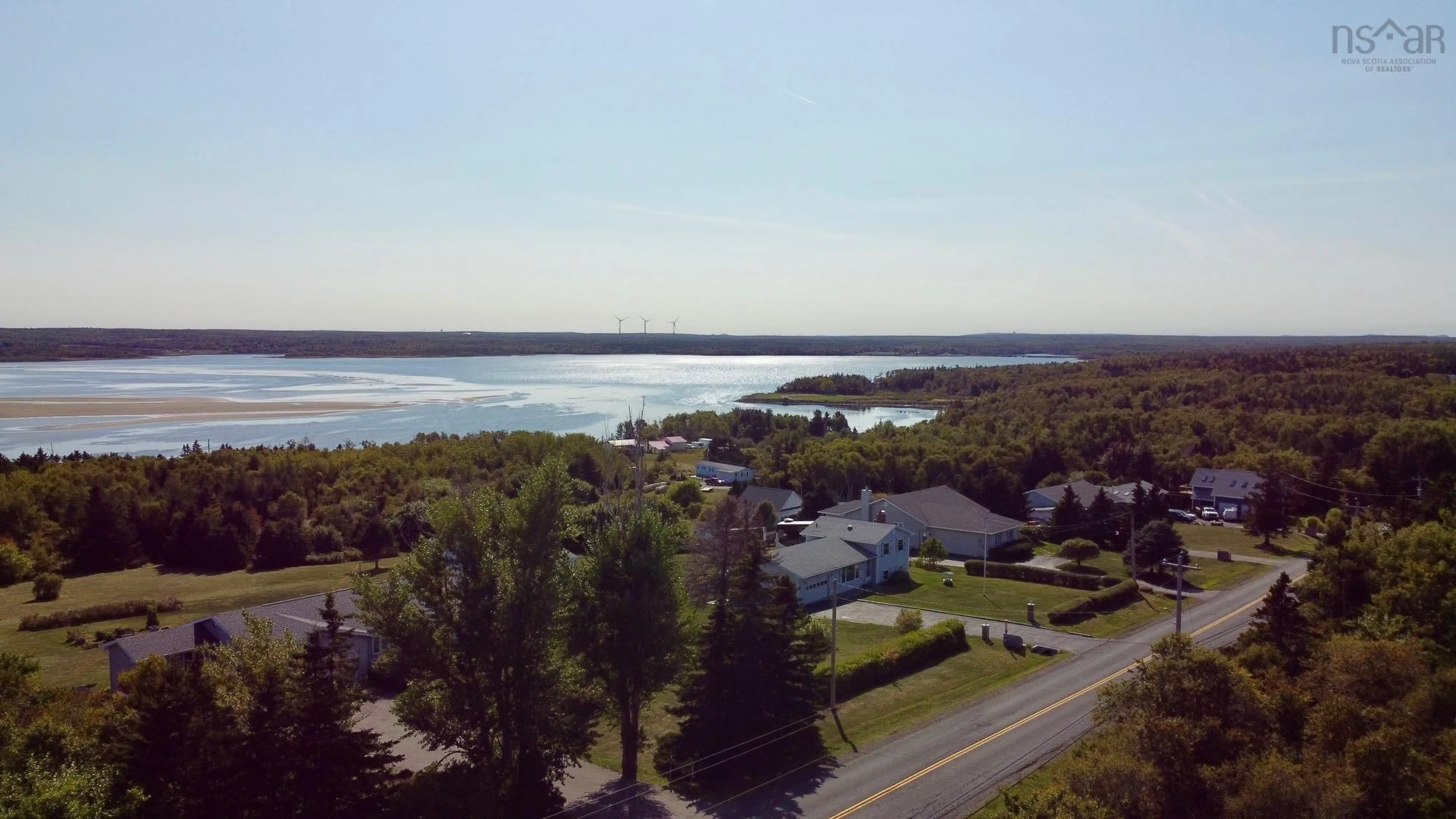 A pic from outside/outdoor area/front of a property/back of a property/a pic from drone, water/lake/river/ocean view for 2695 Lingan Rd, Lingan Nova Scotia B1H 5E7