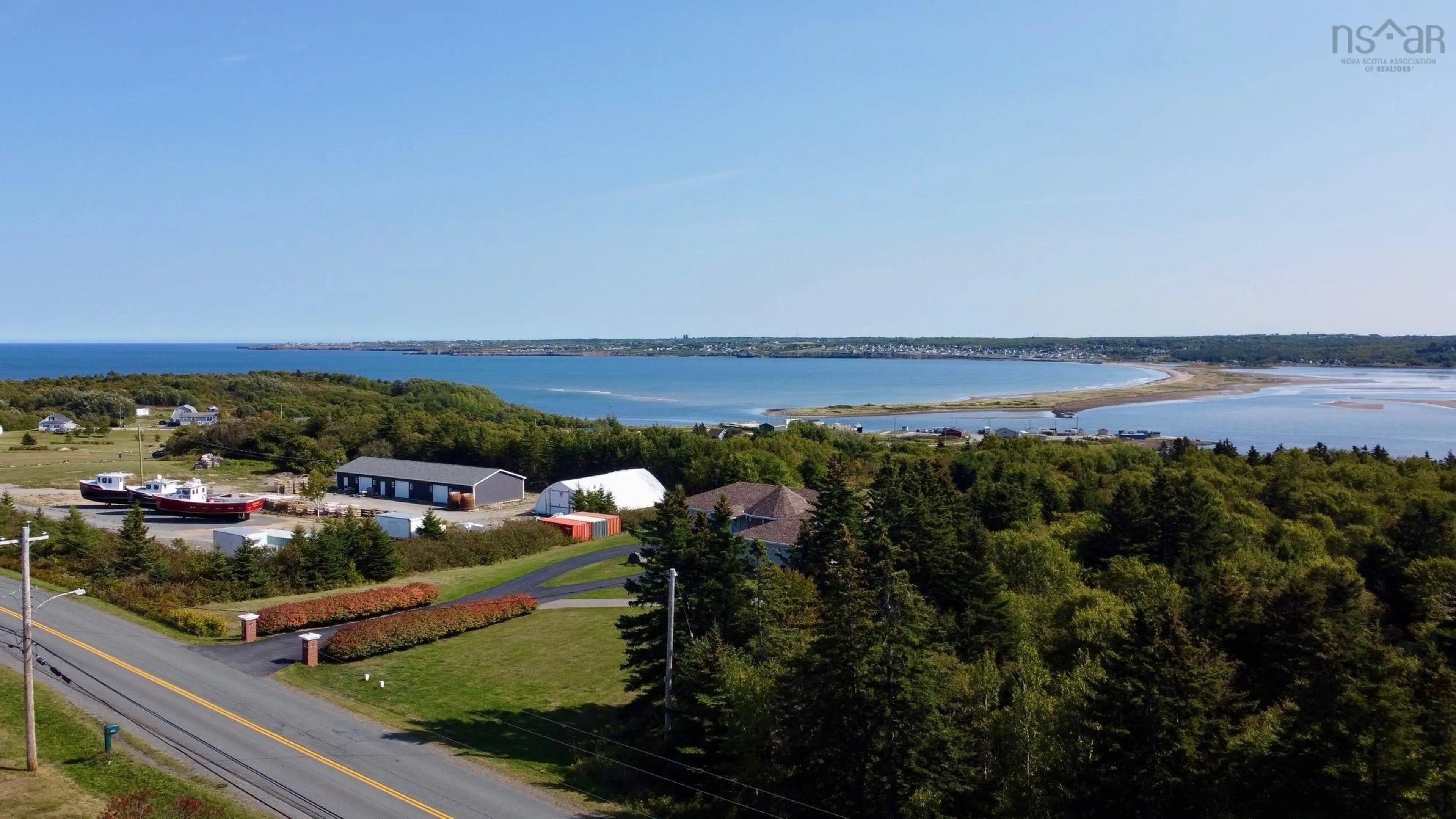 A pic from outside/outdoor area/front of a property/back of a property/a pic from drone, water/lake/river/ocean view for 2695 Lingan Rd, Lingan Nova Scotia B1H 5E7