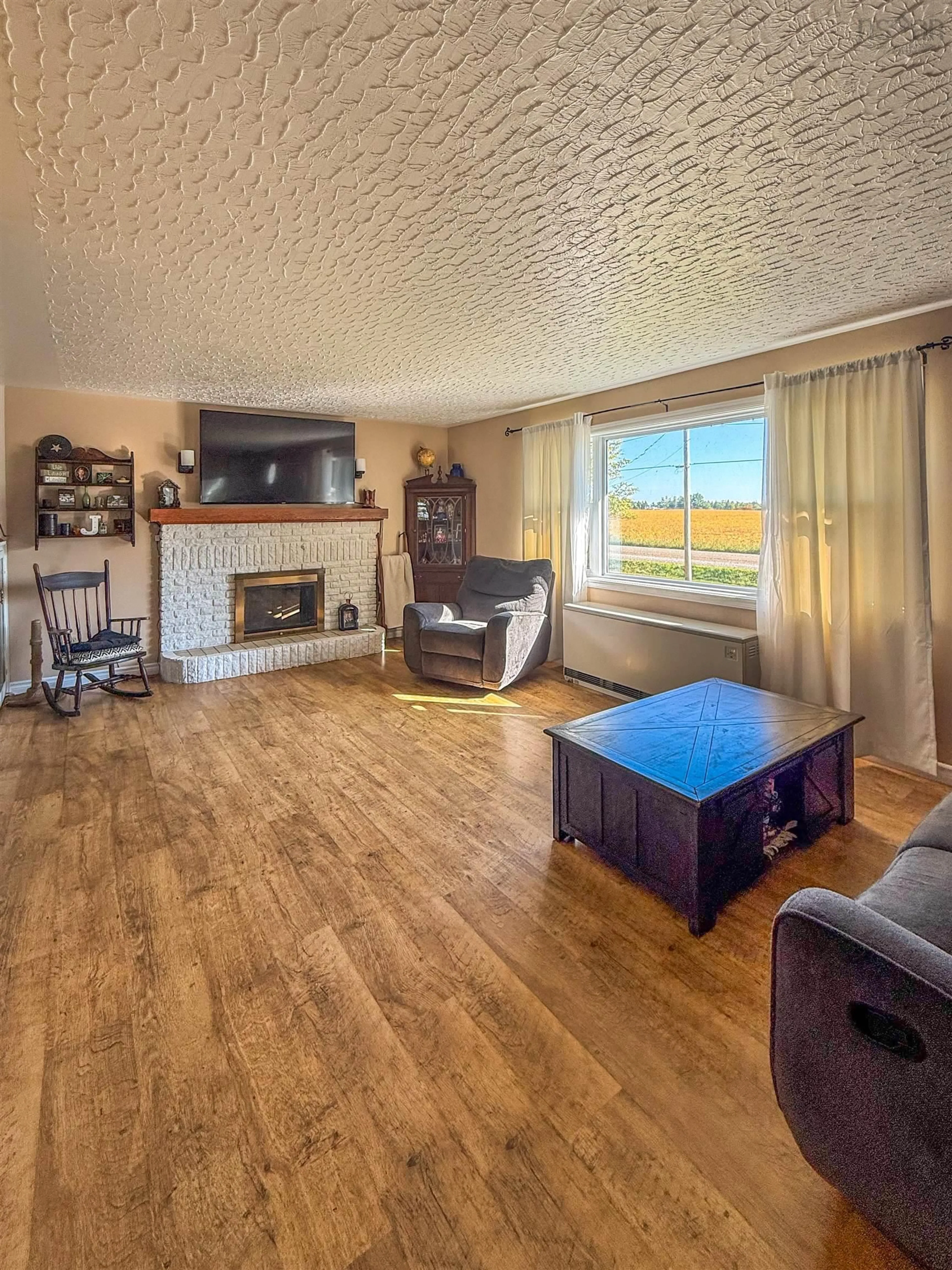 Living room with furniture, wood/laminate floor for 122 Fort Belcher Rd, Lower Onslow Nova Scotia B0M 1C0