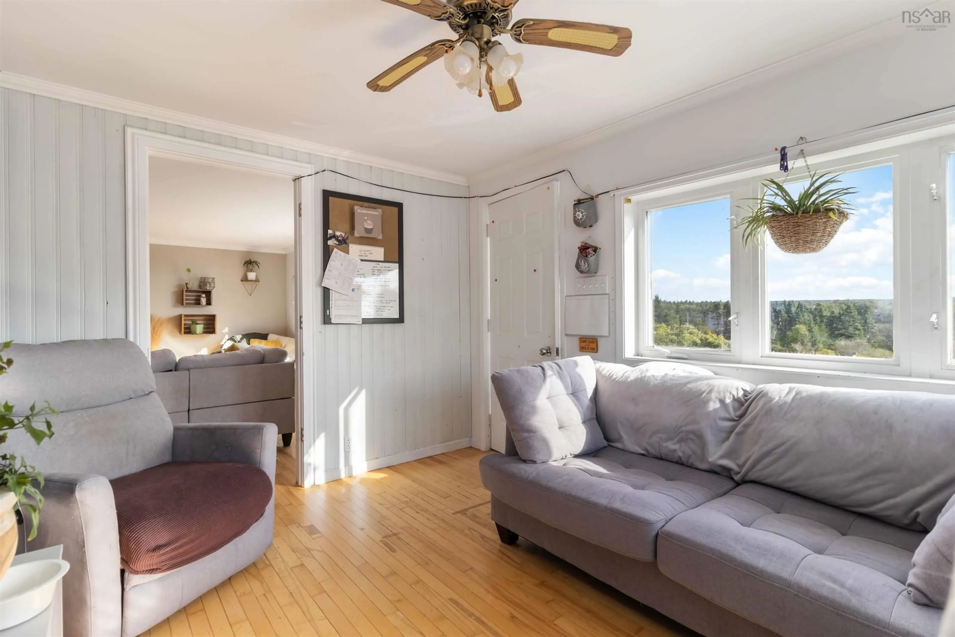 Living room with furniture, wood/laminate floor for 21 Littles Rd, Terence Bay Nova Scotia B3T 1Y7