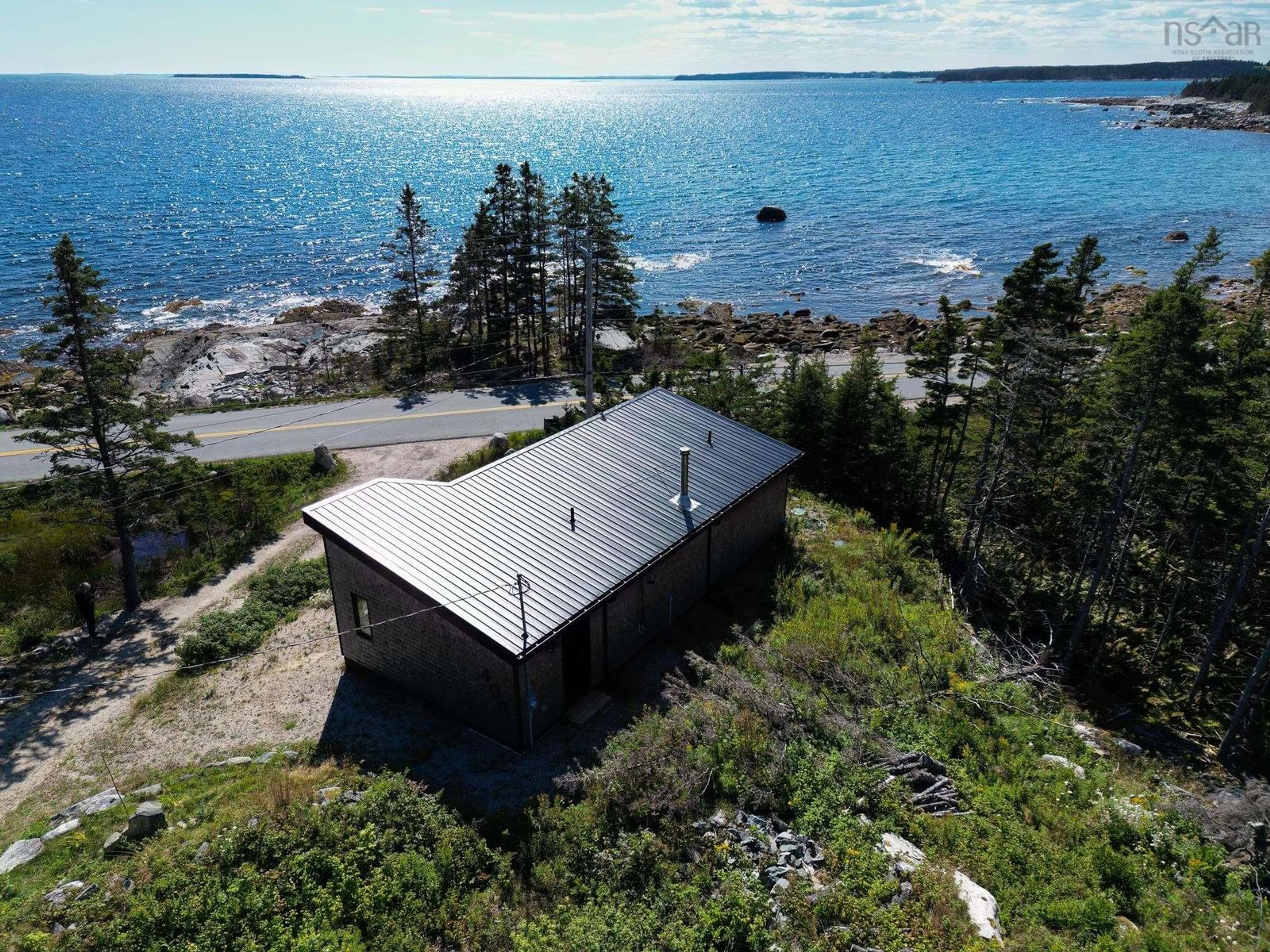 A pic from outside/outdoor area/front of a property/back of a property/a pic from drone, water/lake/river/ocean view for 405 & 407 New Harbour Rd, New Harbour Nova Scotia B0J 1T0
