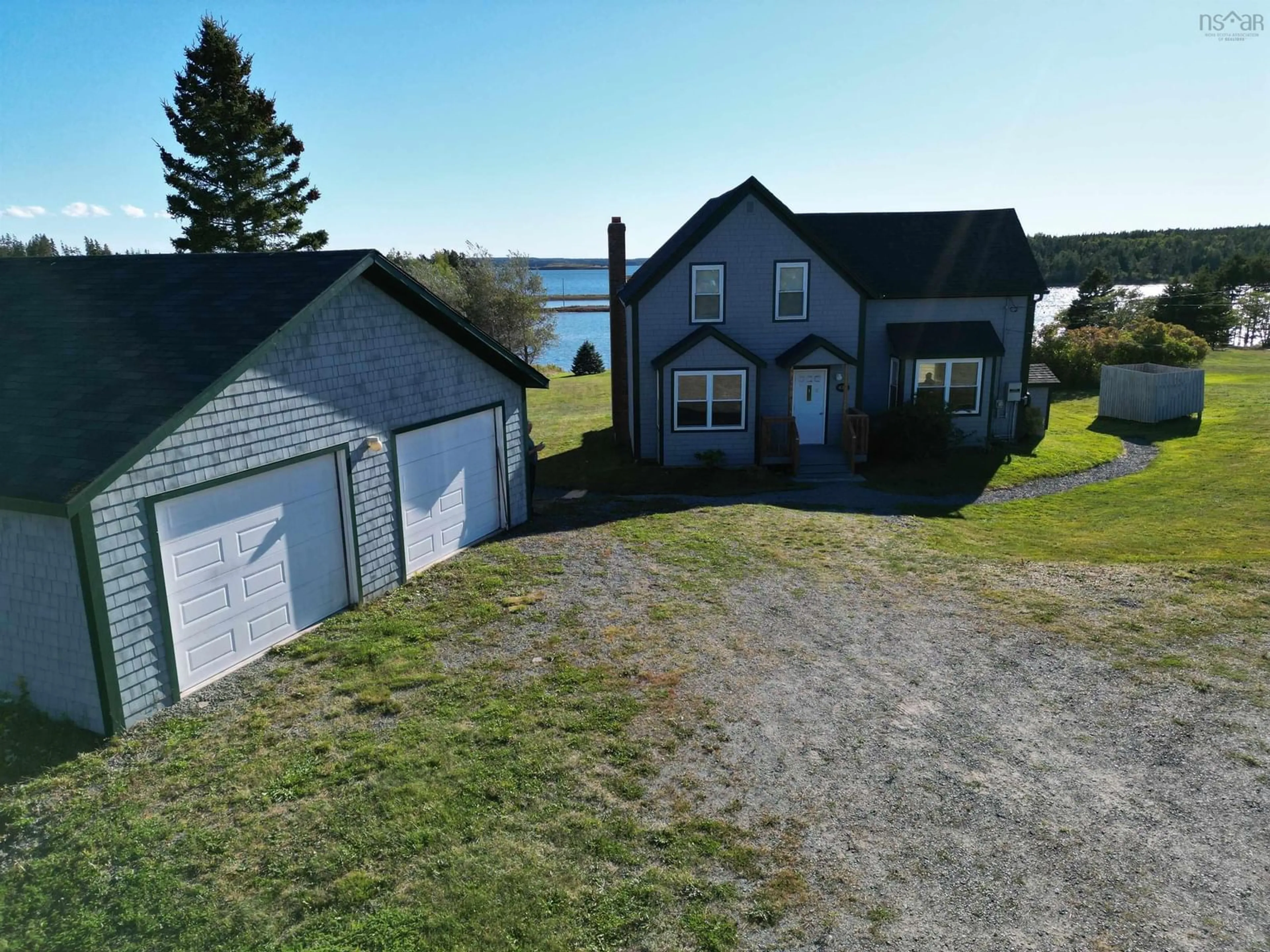 A pic from outside/outdoor area/front of a property/back of a property/a pic from drone, water/lake/river/ocean view for 420 Church Point Rd, River Bourgeois Nova Scotia B0E 2X0