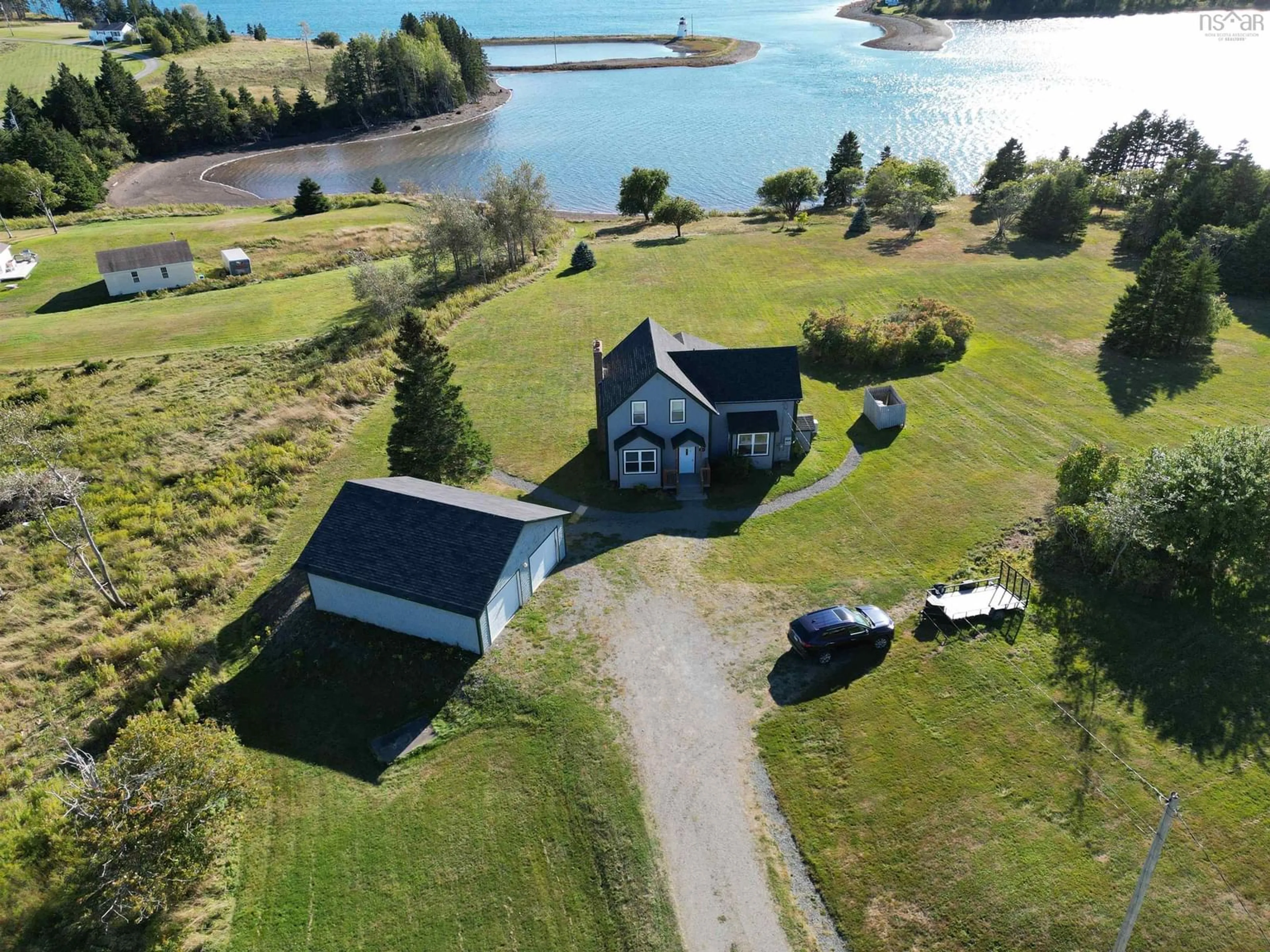 A pic from outside/outdoor area/front of a property/back of a property/a pic from drone, water/lake/river/ocean view for 420 Church Point Rd, River Bourgeois Nova Scotia B0E 2X0