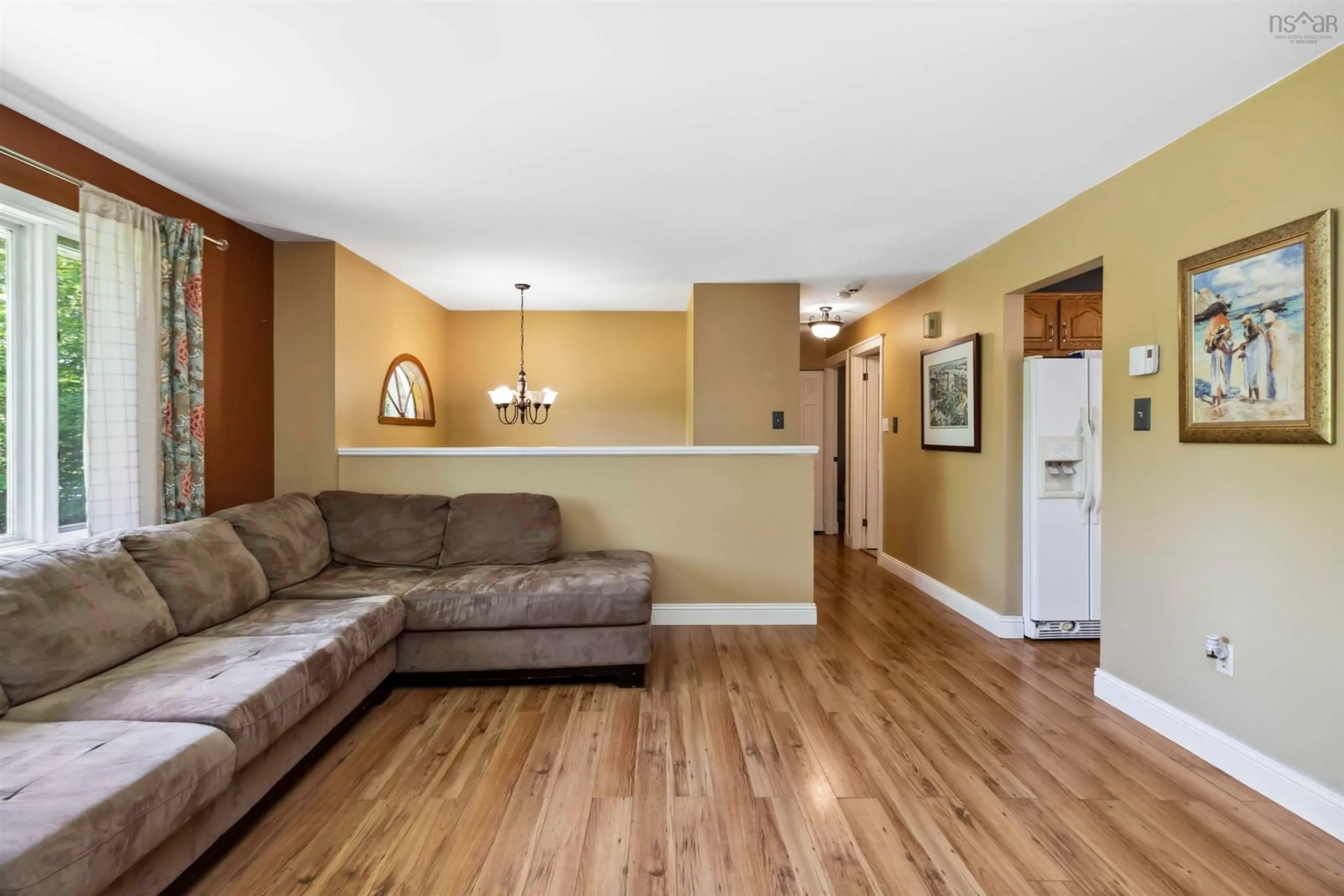 Living room with furniture, wood/laminate floor for 746 Myra Rd, Porters Lake Nova Scotia B3E 1G5