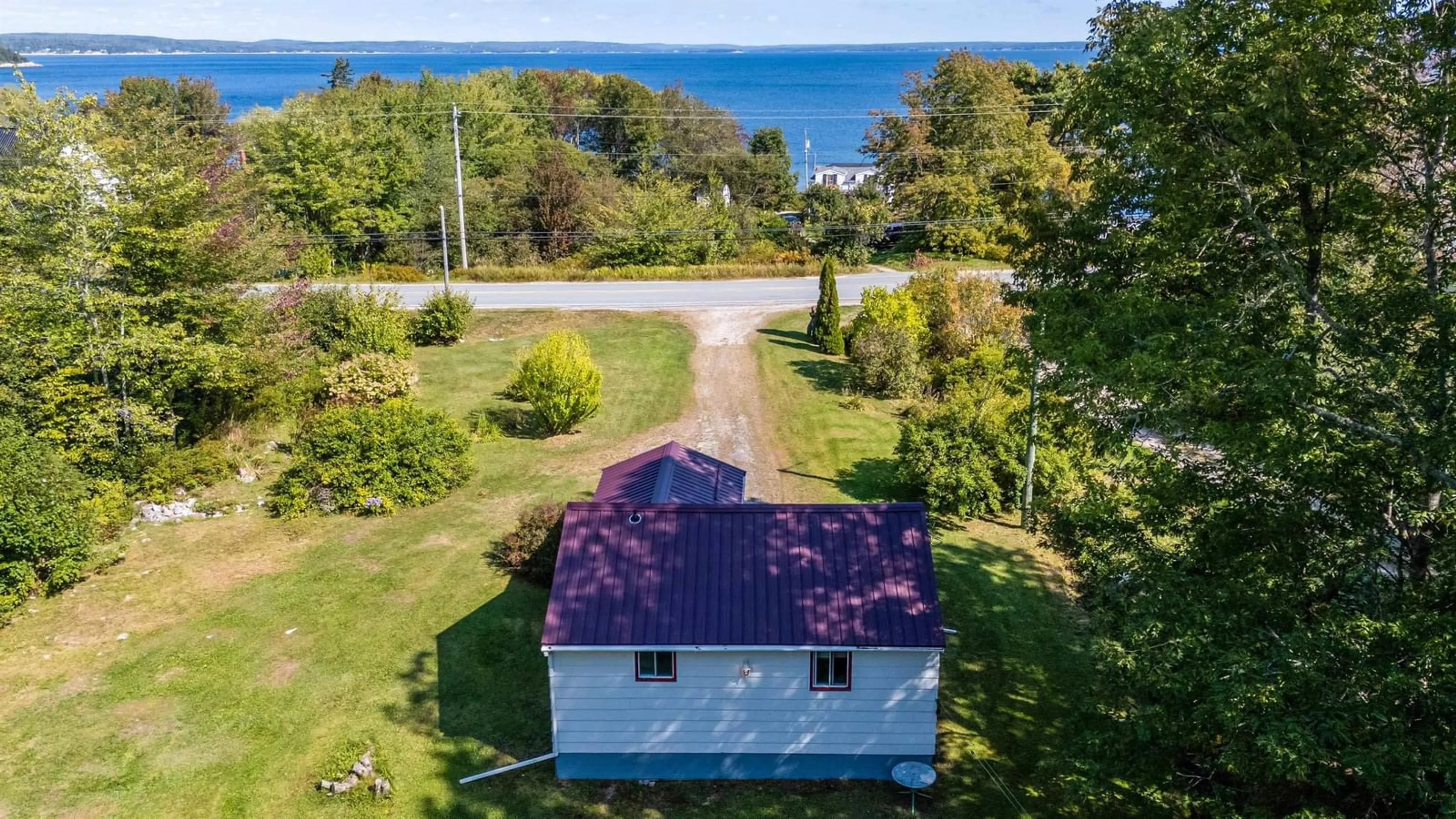 A pic from outside/outdoor area/front of a property/back of a property/a pic from drone, water/lake/river/ocean view for 1236 Highway 329, Mill Cove Nova Scotia B0J 1T0