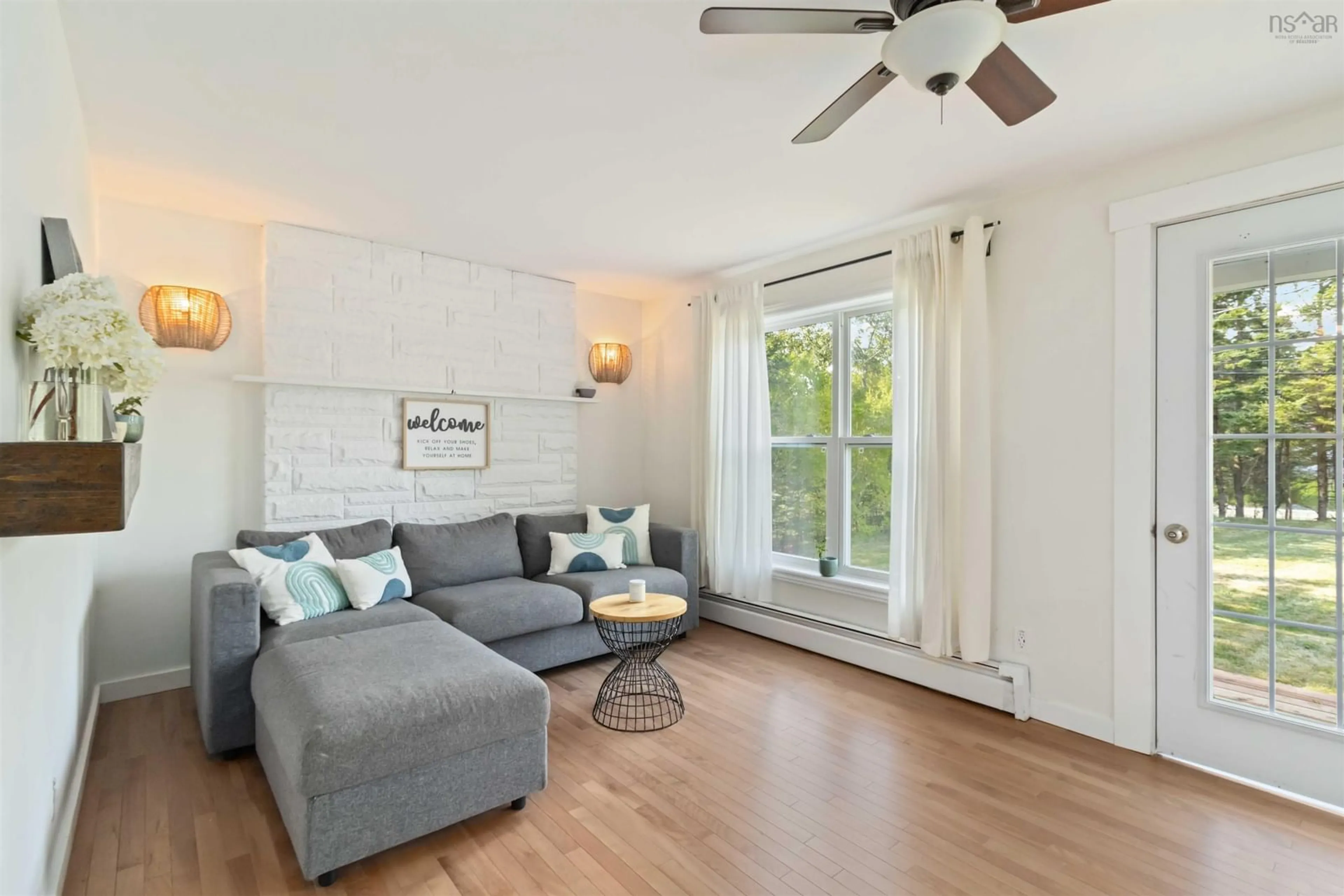 Living room with furniture, wood/laminate floor for 5808 Highway 7, Head Of Chezzetcook Nova Scotia B3E 0G5