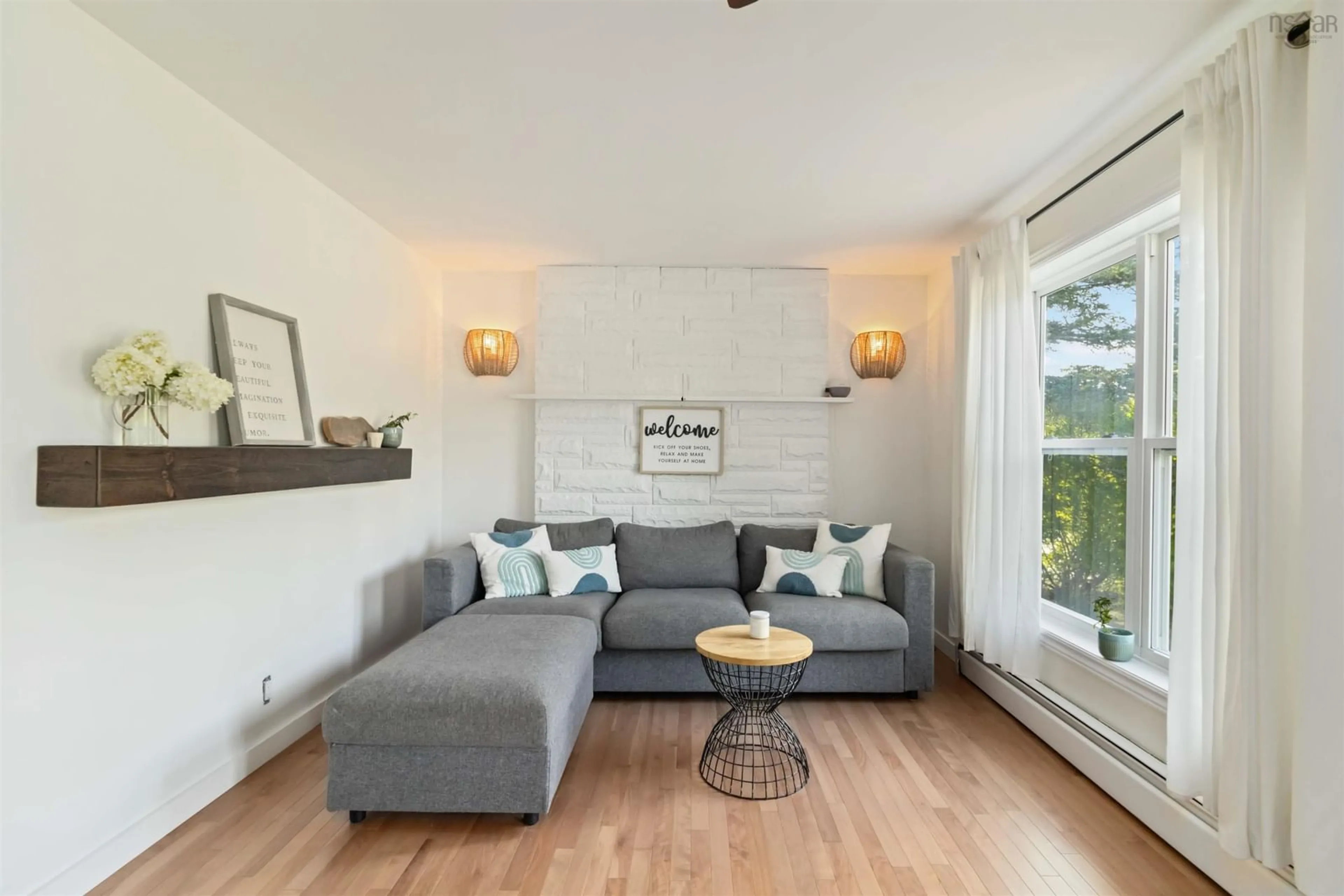 Living room with furniture, wood/laminate floor for 5808 Highway 7, Head Of Chezzetcook Nova Scotia B3E 0G5