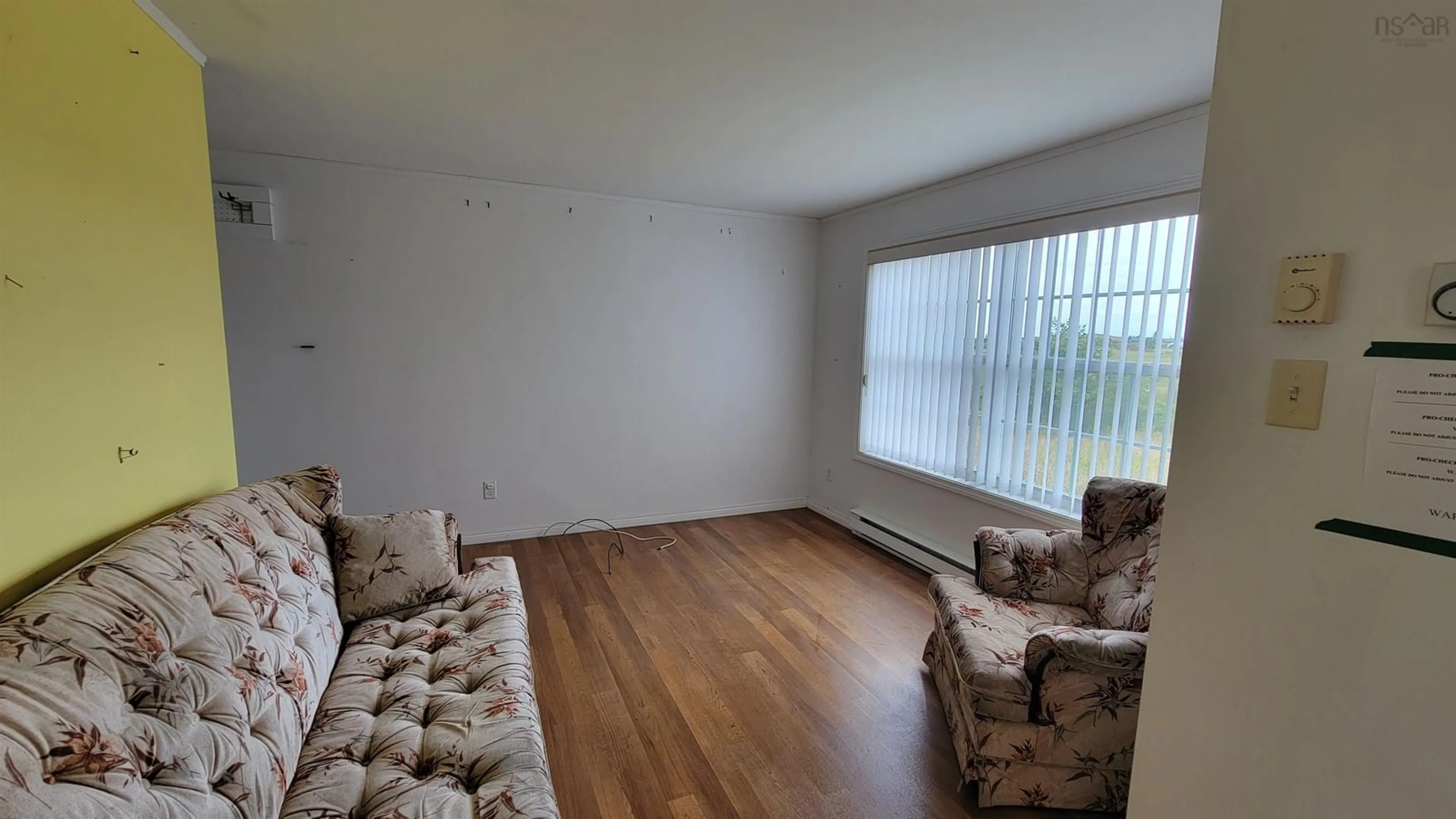 Living room with furniture, wood/laminate floor for 1082 Main Shore Rd, North Chegoggin Nova Scotia B5A 5H2