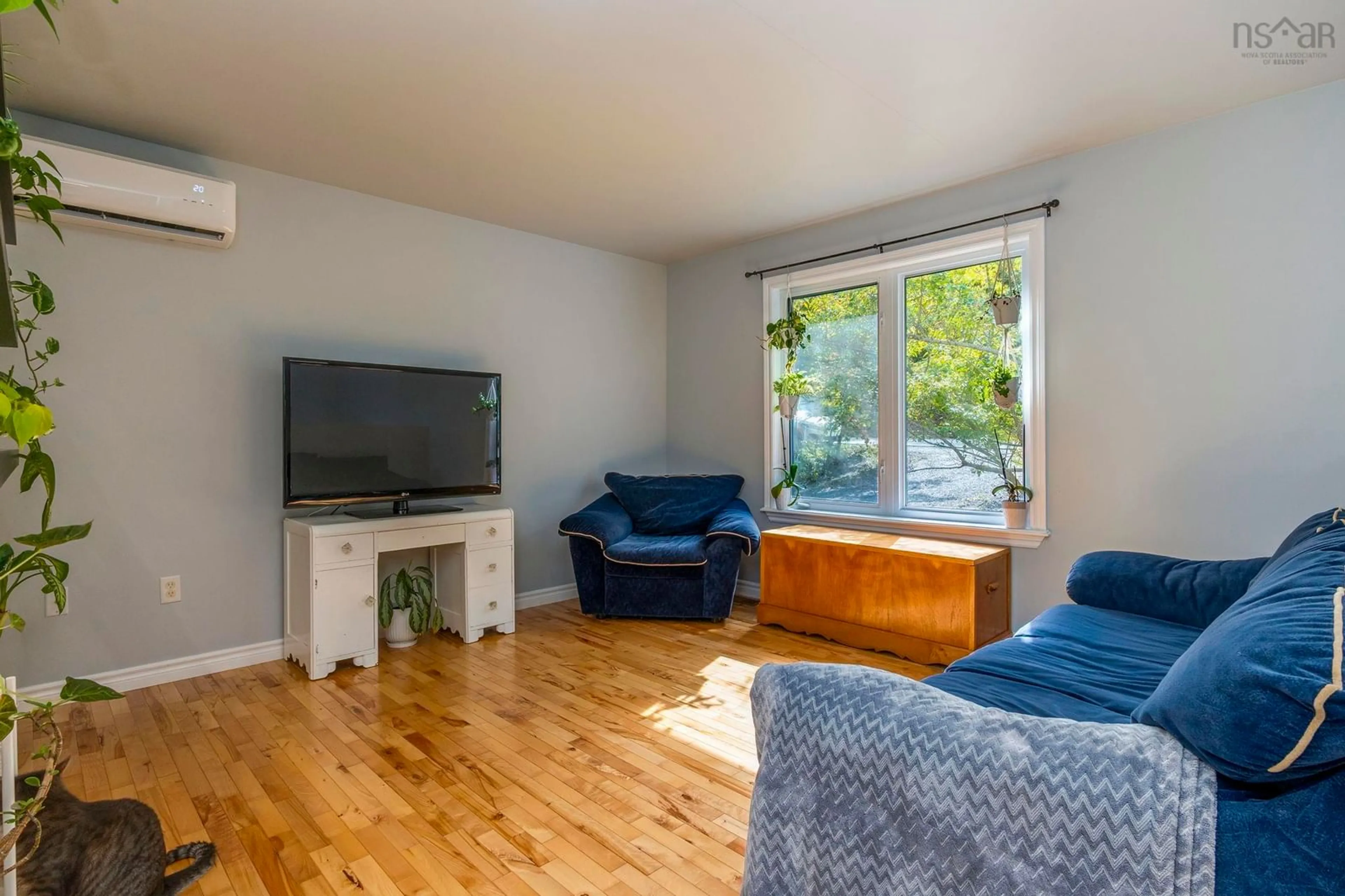 Living room with furniture, wood/laminate floor for 1309 Myra Rd, Porters Lake Nova Scotia B3E 1G9