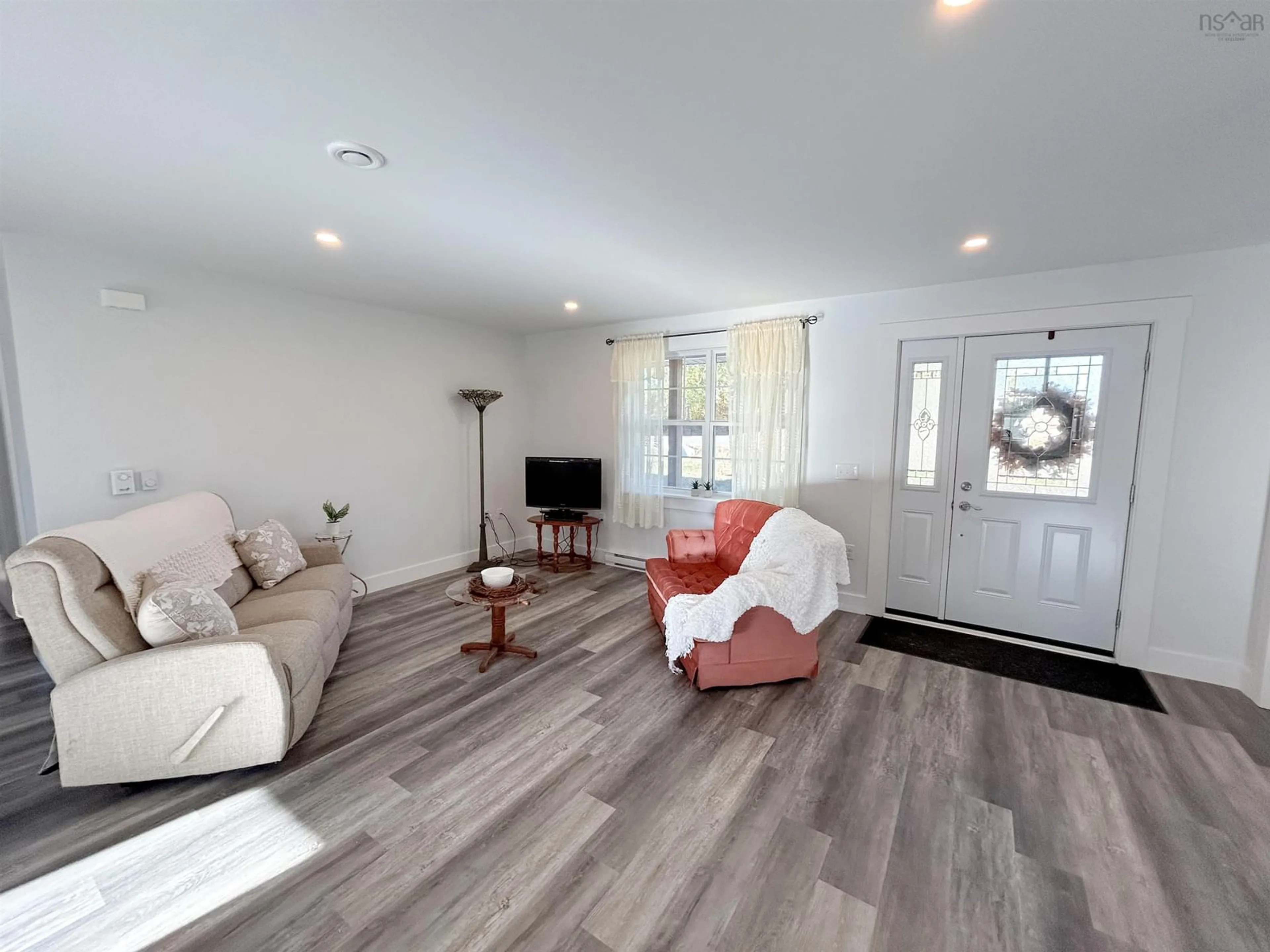 Living room with furniture, wood/laminate floor for 439 Victoria Rd, Spa Springs Nova Scotia B0S 1P0