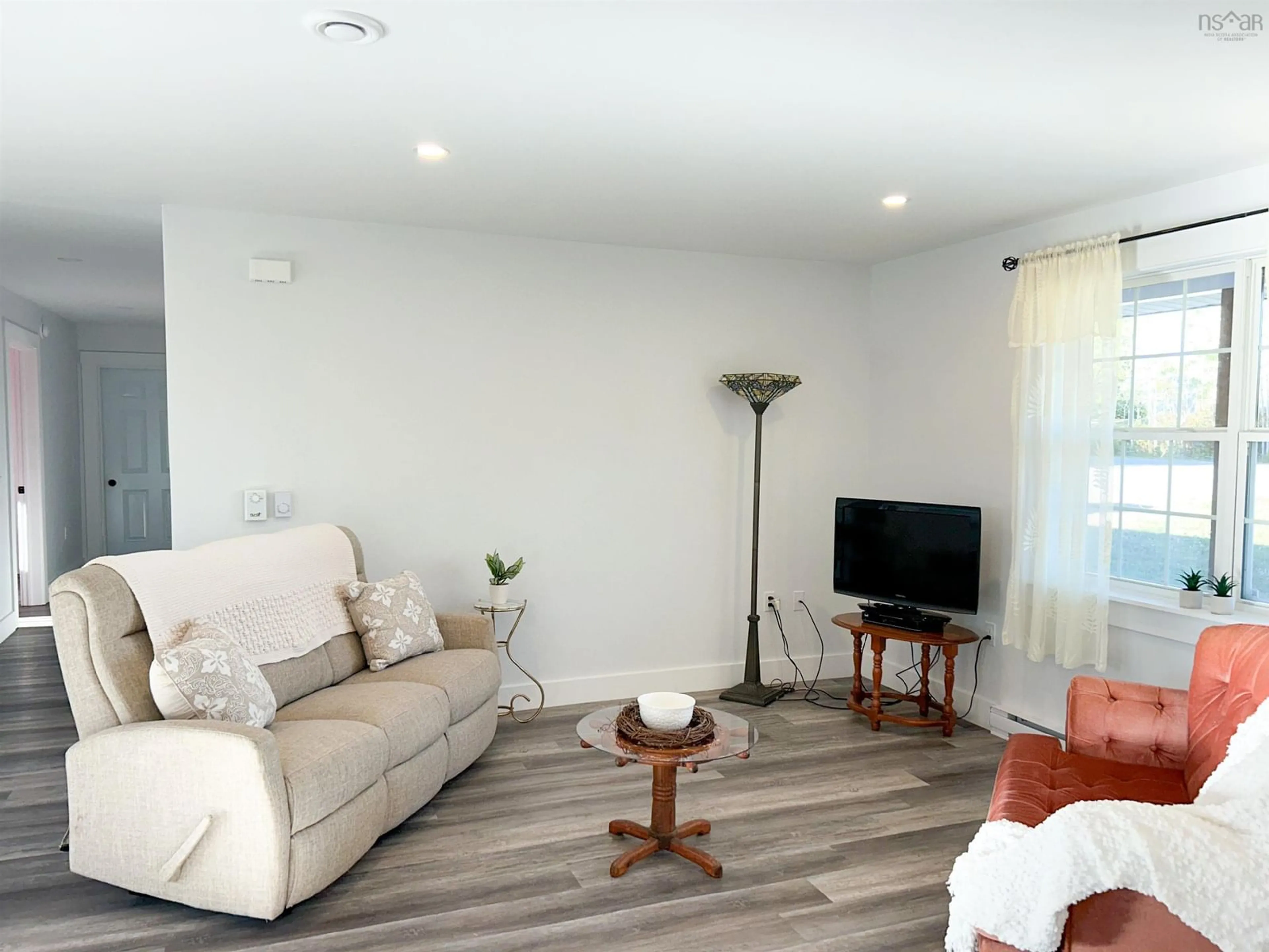 Living room with furniture, wood/laminate floor for 439 Victoria Rd, Spa Springs Nova Scotia B0S 1P0